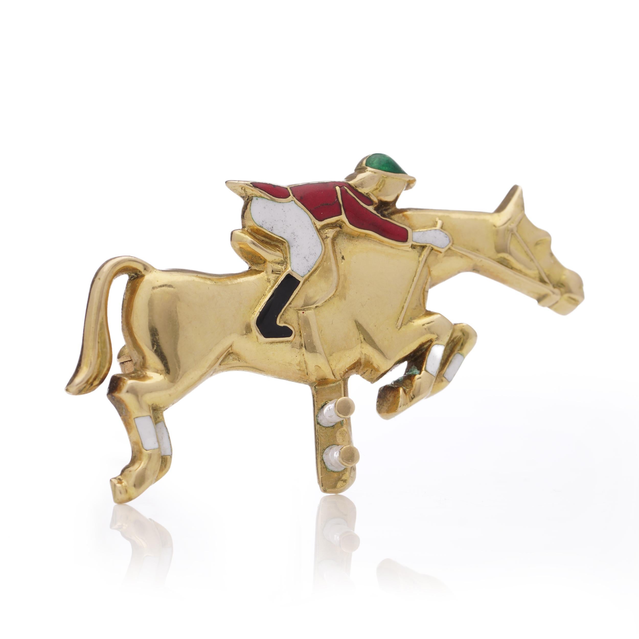 The Jacques Lacloche Paris Cannes brooch crafted from 18 kt. yellow gold and colourful enamel portrays a scene of a jockey and horse competing moment when the horse and rider overcome obstacles on the course, showcasing the skill and grace of the