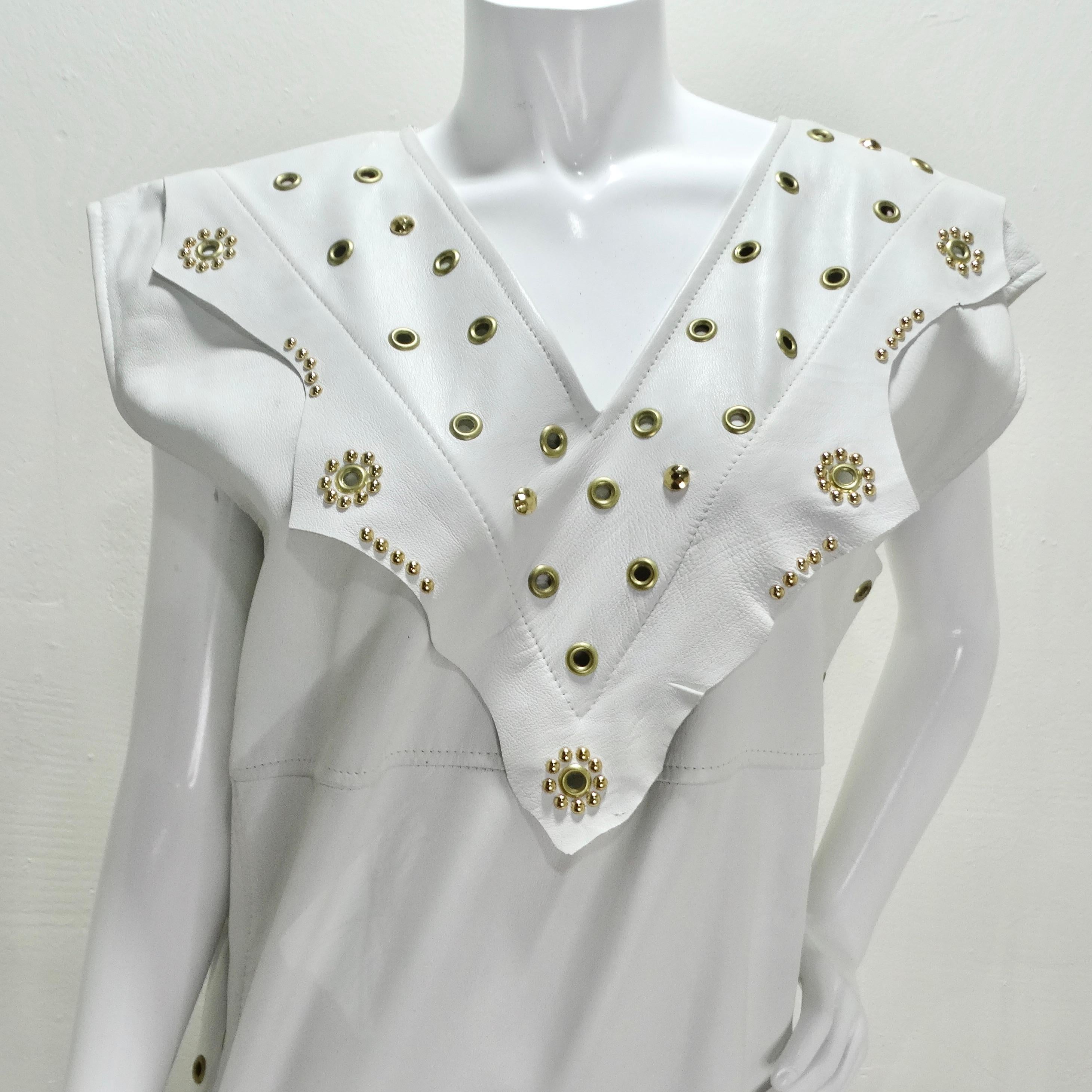 Step into the glamour of the 1980s with our Jacques Lelong White Leather Studded Dress—a striking and captivating piece that effortlessly combines bold style with luxurious detailing. Embrace the allure of the 1980s with this sleeveless, bodycon