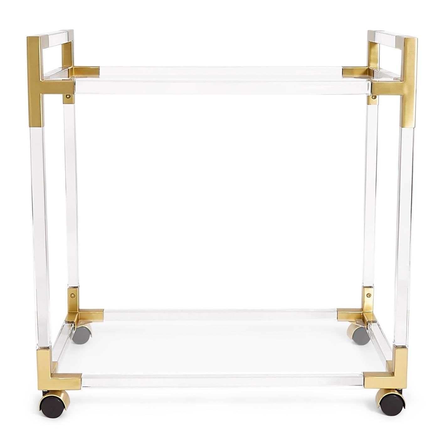 Clearly cool. Bar carts are the swankiest of all home decors. Two glass shelves offer plenty of space for your chosen aperitif and your fabulous barware. Shown in ethereal transparent Lucite with brushed brass accents.