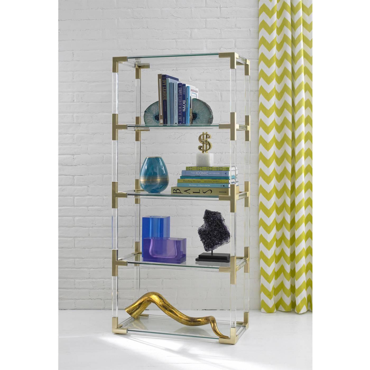Clearly cool. Our Jacques collection is the perfect blend of simplicity and glamour, modern and traditional. Shown in crystal clear Lucite with brushed brass. Also available in moody smoke acrylic with nickel corners. Fab for books or for displaying