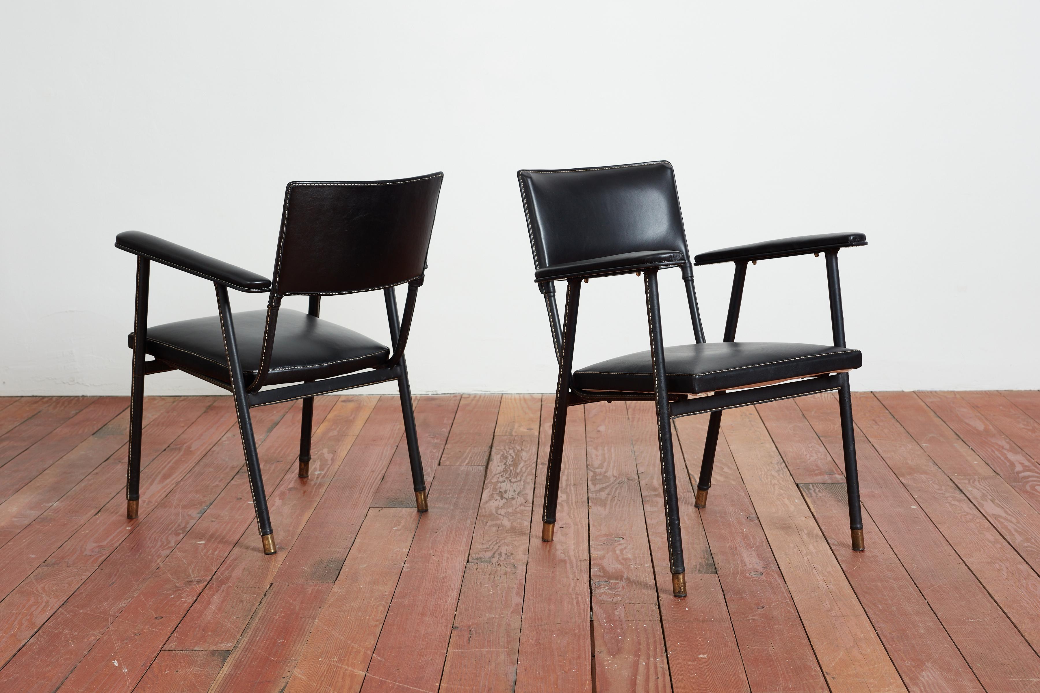 Poltrone Jacques Quinet in pelle nera con cuciture a mano a contrasto e spessi piedi in ottone. 

Splendide gambe angolate e patina sulle gambe in pelle. 
I sedili sono stati tappezzati di recente in Francia. 

Possono essere utilizzate come sedie