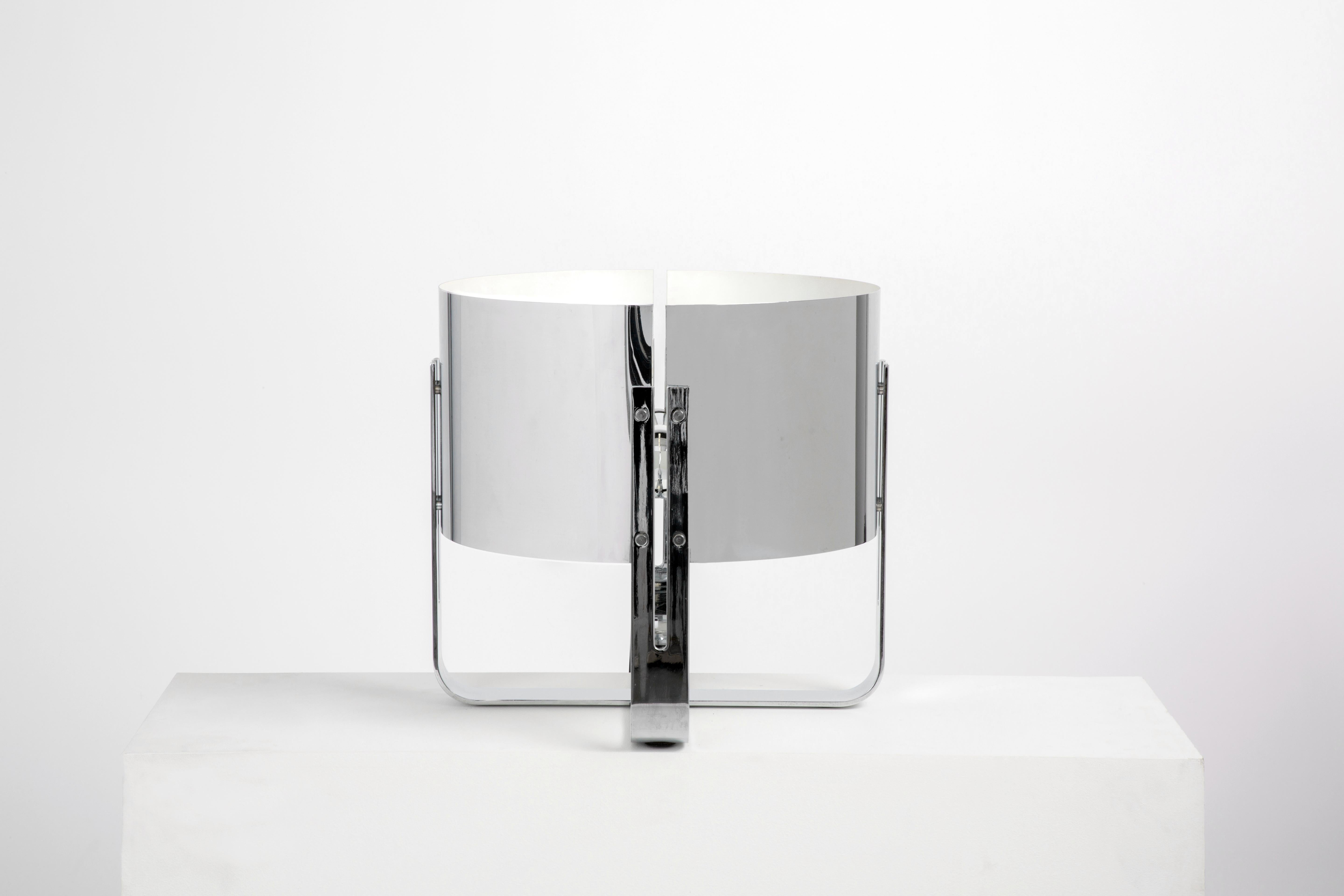 This is a chrome lamp with a cruciform base. Scale is good for placement on a large table or the floor.

Wired to US standards. One Edison socket. 

Jaques Quinet (1918-1992) was one of the most successful designers of the mid Twentieth century. His