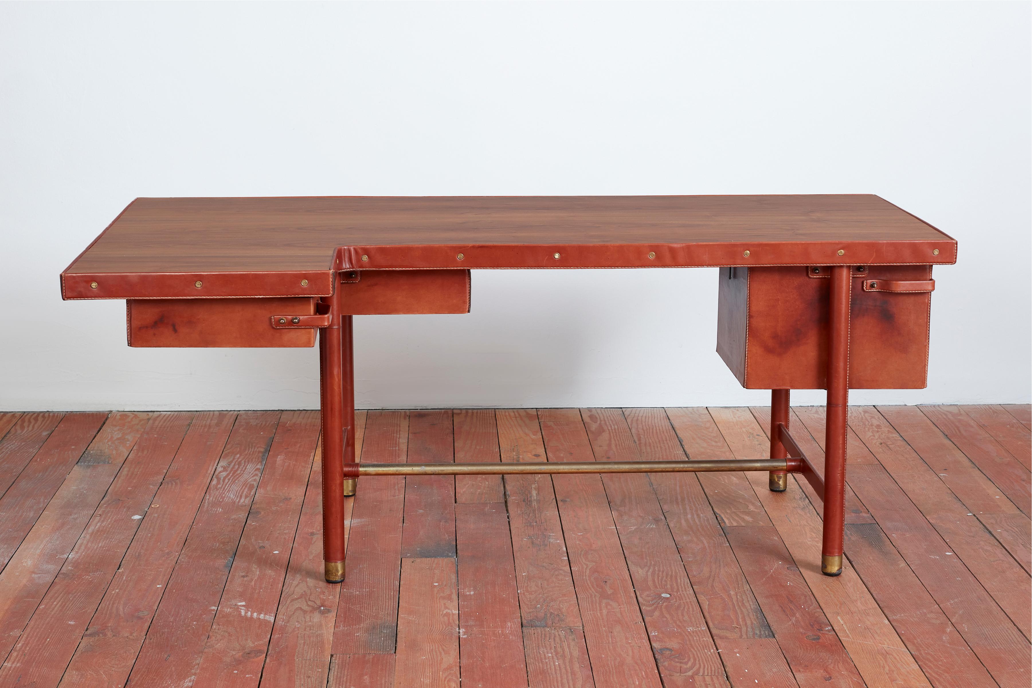 Incredible Jacques Quinet Executive desk, circa 1950s
Rich caramel leather with contrast open stitching and fully swiveling drawers on both sides including a filing cabinet with leather handles.
Rare boomerang shape with ashwood top
Signature