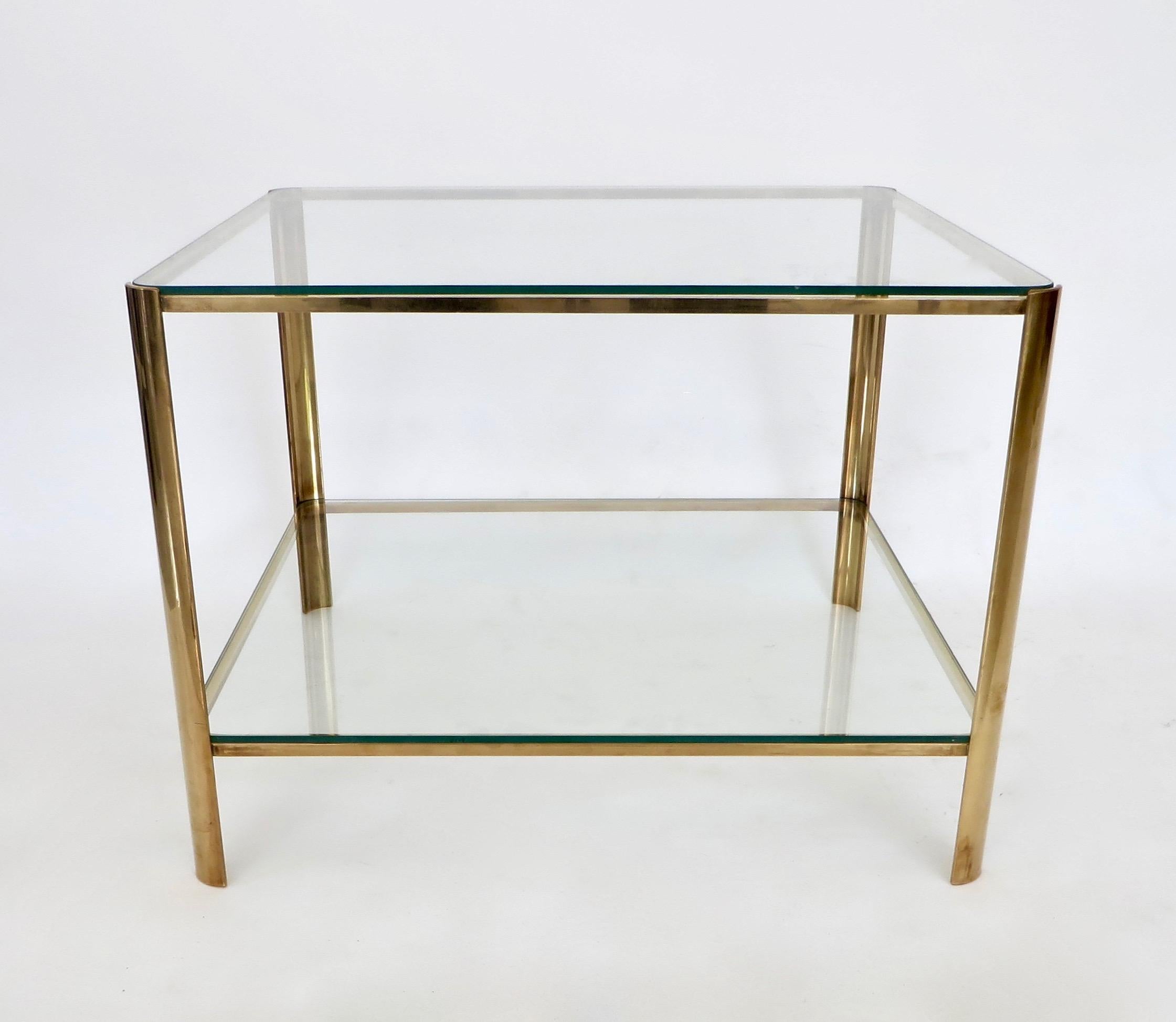 Occasional side or coffee table signed by Jacques Quinet and stamped by Broncz for Maison Malabert. 
It features a strong bronze base and excellent condition original glass with no scratches. Nice patina. 
The glass top and bottom plateau adds