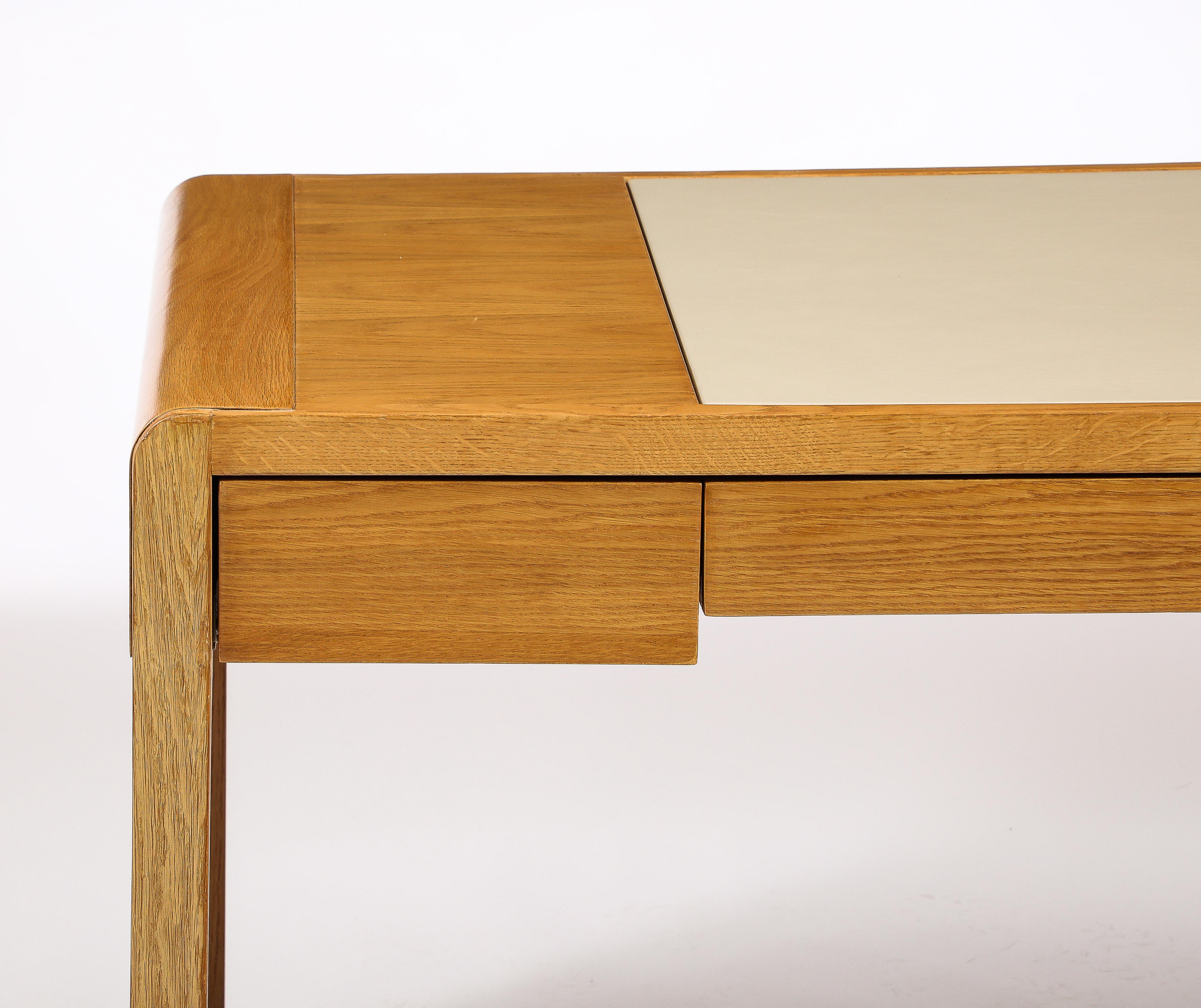 Mid-Century Modern Jacques Quinet Oak and Leather Waterfall Desk, France 1960's For Sale