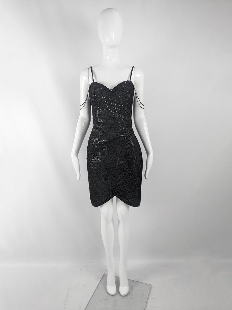 A sexy vintage womens dress from the 80s by luxury French leatherwear designer, Jacques Sac. In a black leather embellished with sequins and a snakeskin print throughout. It has spaghetti straps and beaded straps over the shoulder.

Size: Marked
