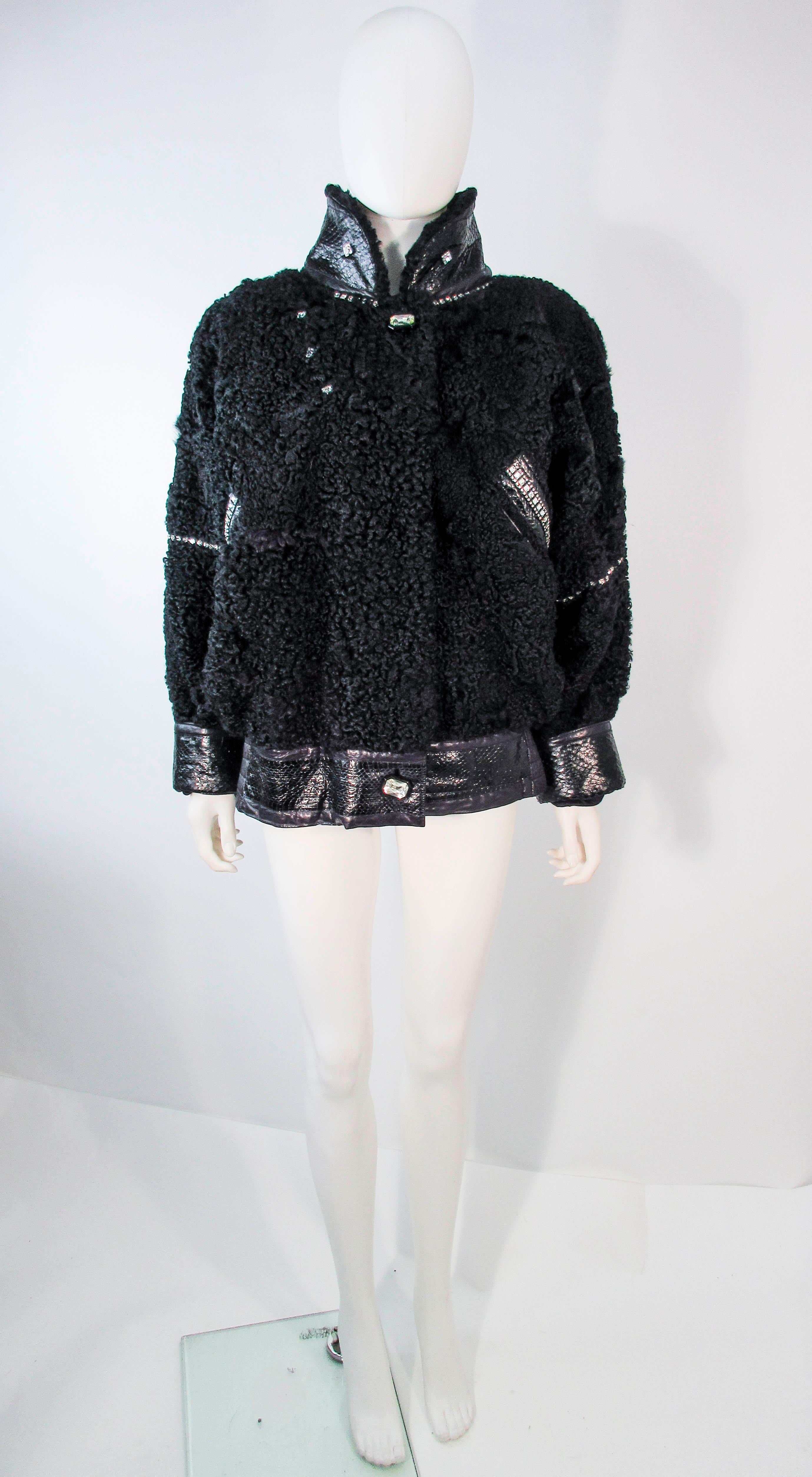 This fabulous jacket is composed of a black lamb jacket, features rhinestones with snakeskin trim. There are side pockets and a center front zipper with rhinestone buttons. In excellent vintage condition, some signs of wear due to age. Please feel