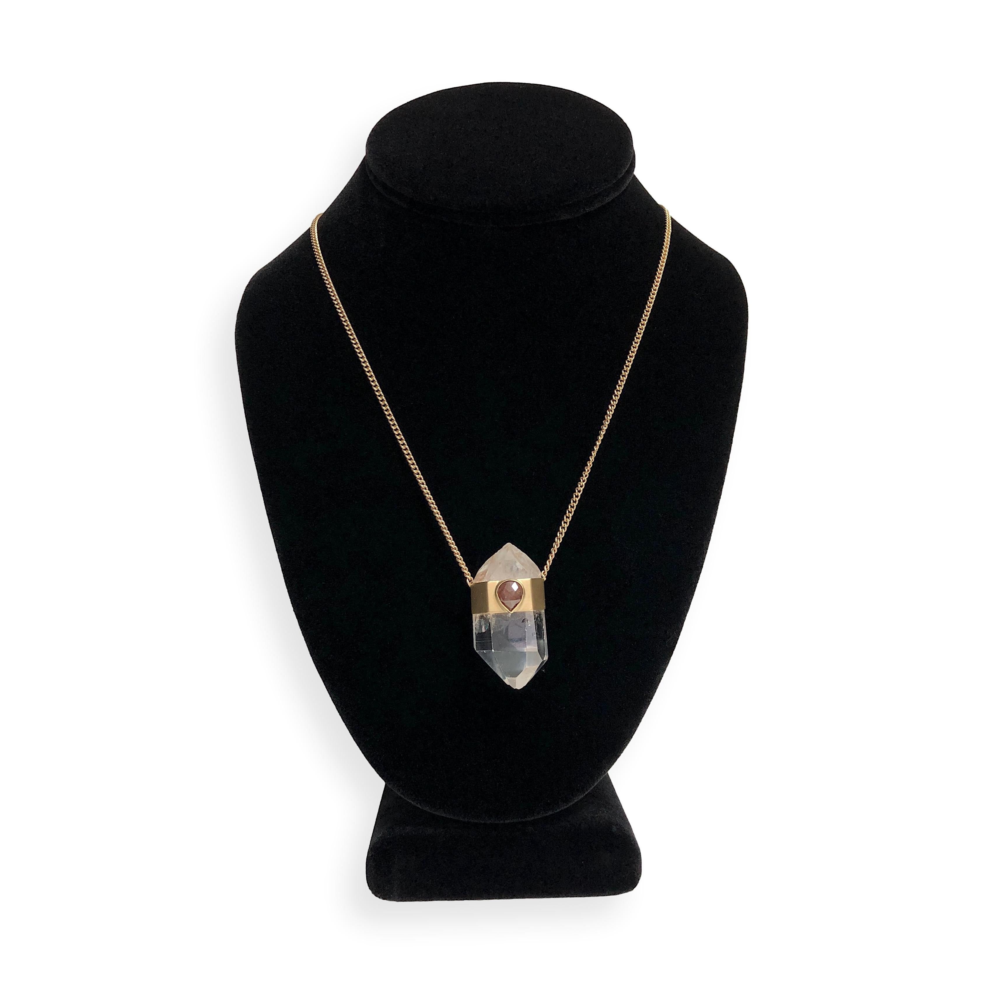 This Jacquie Aiche necklace features a large natural clear quartz point wrapped in 14K yellow gold, accented by a bezel-set teardrop-shaped rose cut diamond in a warm chocolate hue. The pendant is suspended from a solid 14K yellow gold chain