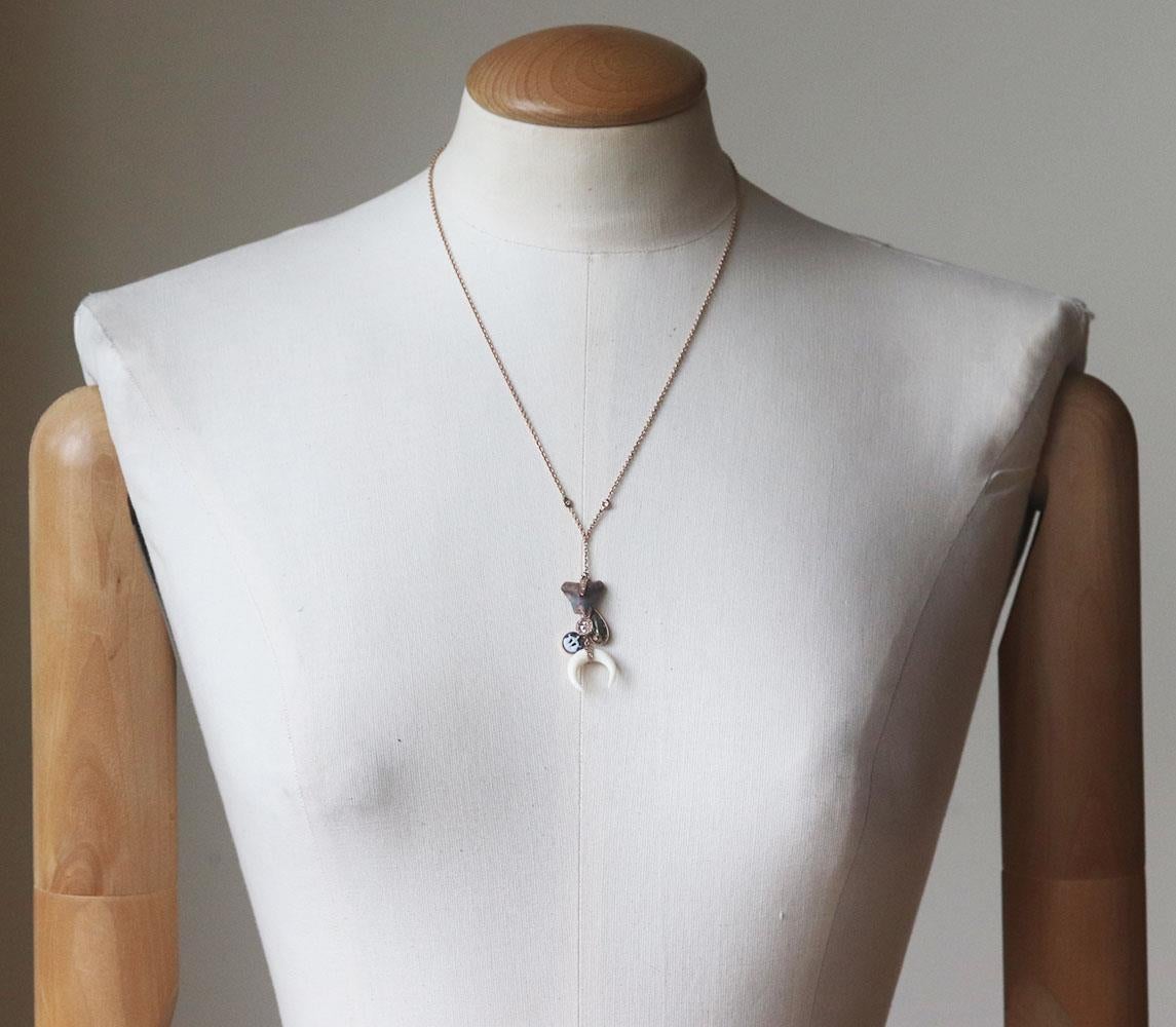 This charm necklace by Jacquie Aiche is a unique piece, it's made of multi-charm necklace including diamonds, double horn, crystals and shark tooth. White horn, tonal-brown shark tooth, 2 white bezel cut diamonds. Does not come with box or dustbag.