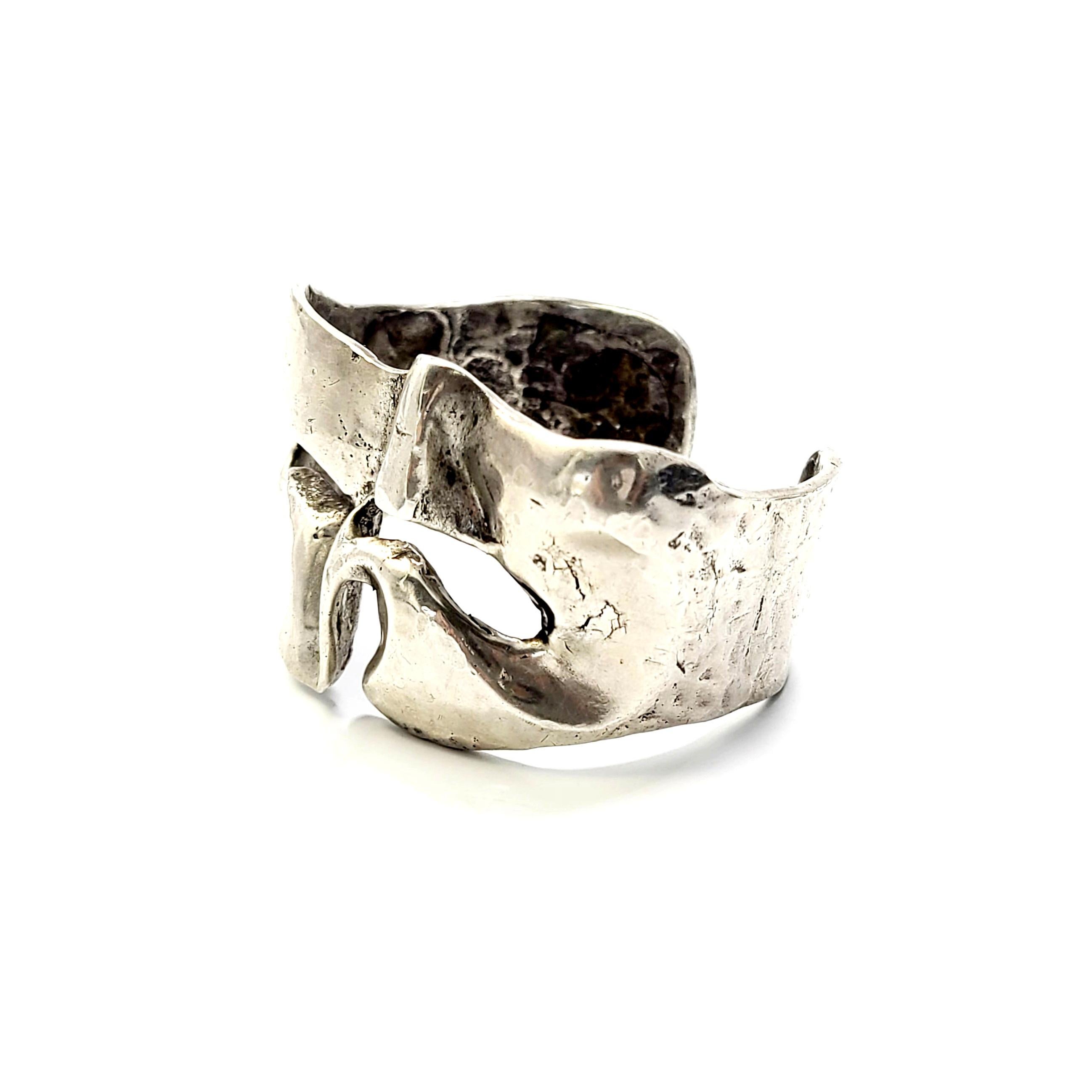 Sterling silver brutalist cuff bracelet, signed JAD.

Free form design with cut-out details.

Measures approx 5 3/8