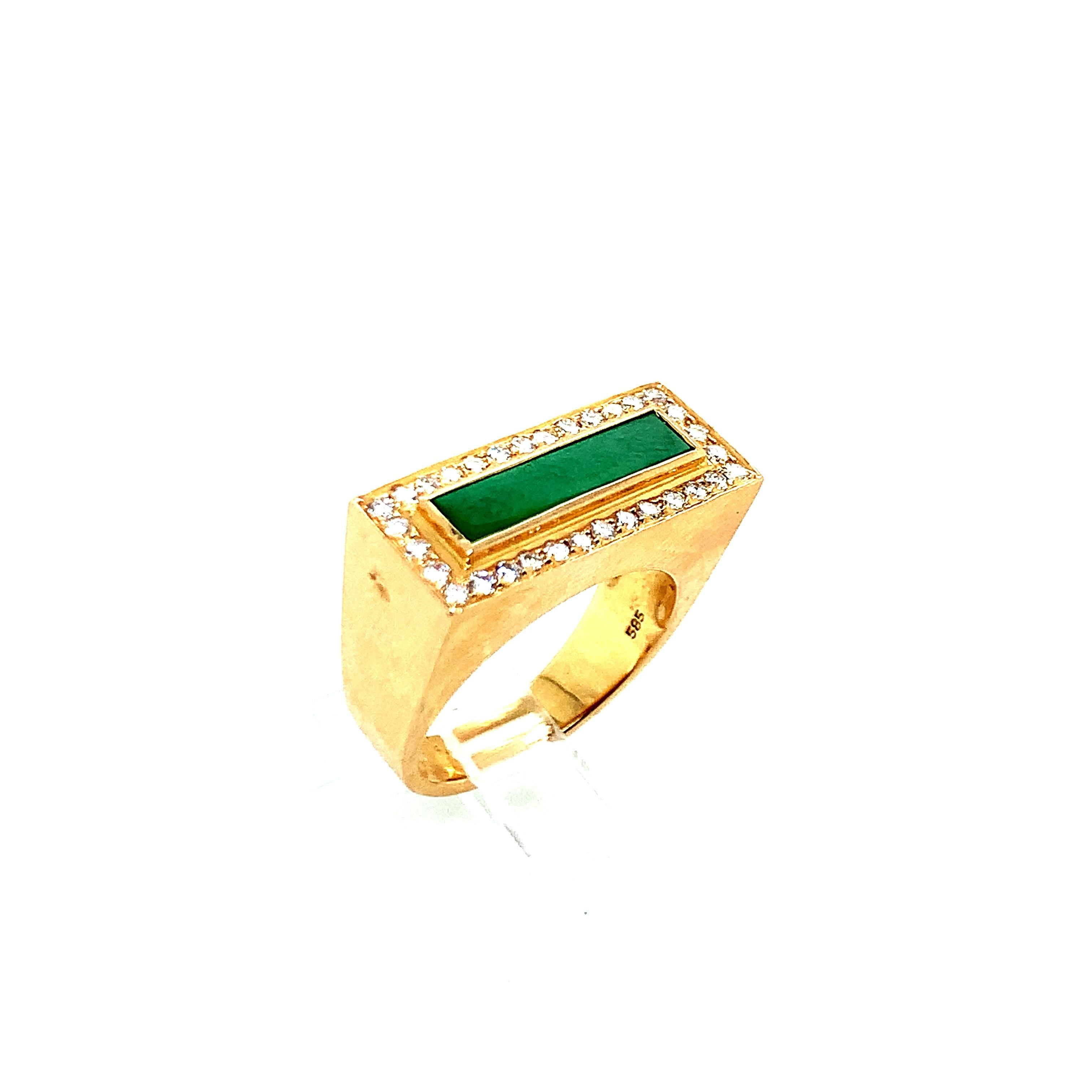A 14 karat gold ring with a natural type A jade at its center. Total weight: 10.3 grams. Size 6.5.