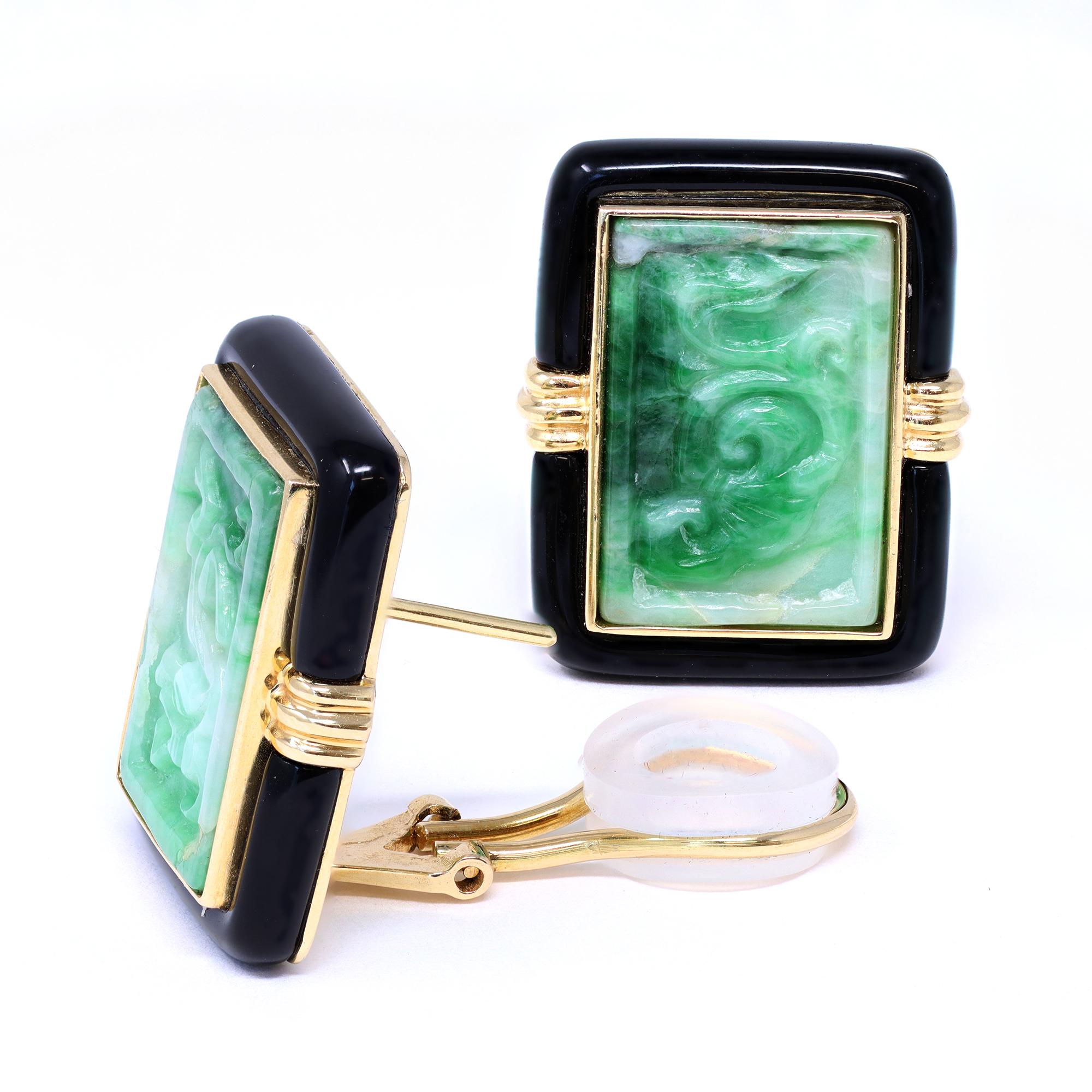 A vintage pair of Jadeite jade carving ear clips with onyx. The jade carvings are natural and untreated, with no indication of dye. The earrings are marked AJF and are set in 14-karat yellow gold. The gross weight is 19 grams. The earrings measure