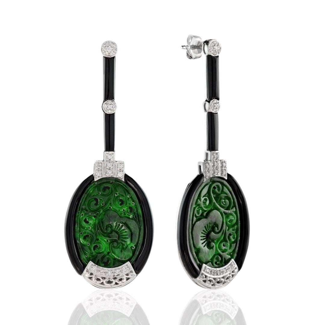 These dangle earrings are truly one of a kind. Each one is unique with a slightly different design. The Jade is 21.57 carats, while the onyx is 12.16 carats. The earrings also feature 48 brilliant round diamonds, weighing 0.33 carats. All of the