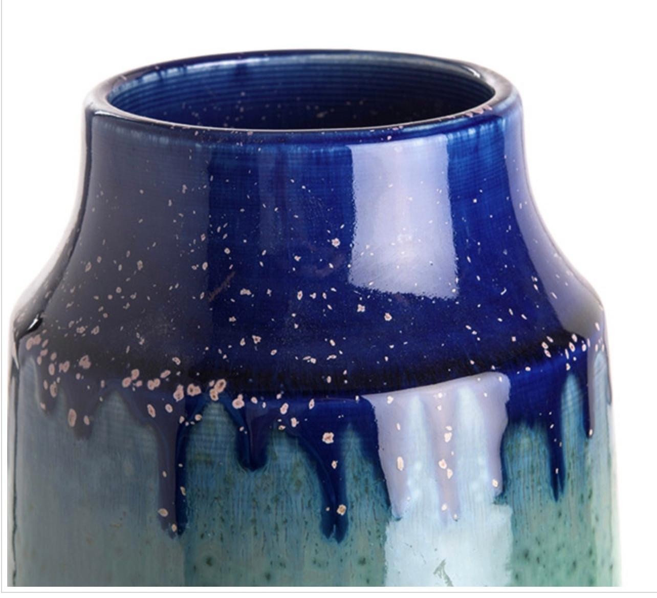 Contemporary Chinese ceramic vase in a tall cylinder shape.
Tapered top in royal blue color showing dripped glaze.
Shades of jade in the body of the vase.
