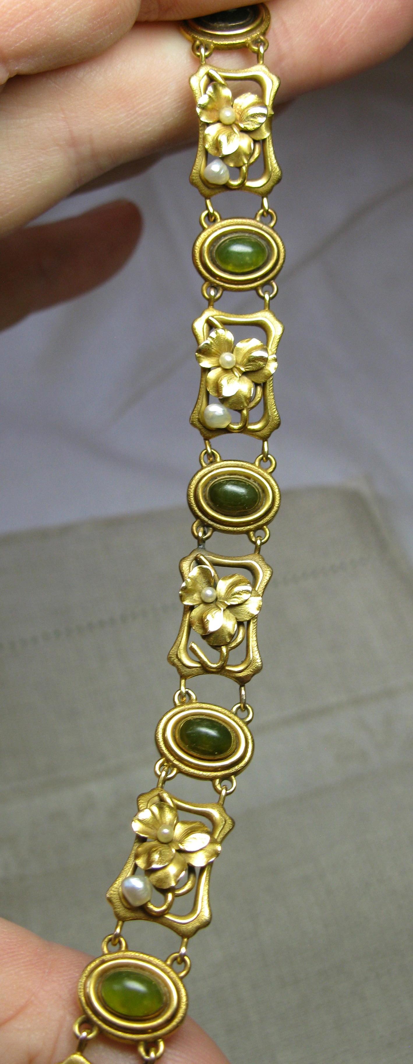 THIS IS A SUPERB RARE JADE ART NOUVEAU BELLE EPOQUE BRACELET WITH 6 EXTRAORDINARY NATURAL ANTIQUE JADE CABOCHONS OF INCREDIBLE BEAUTY SET IN A 14 KARAT GOLD ART NOUVEAU SETTING WITH FULLY MODELED THREE-DIMENSIONAL PANSY FLOWERS WITH PEARL ACCENTS IN