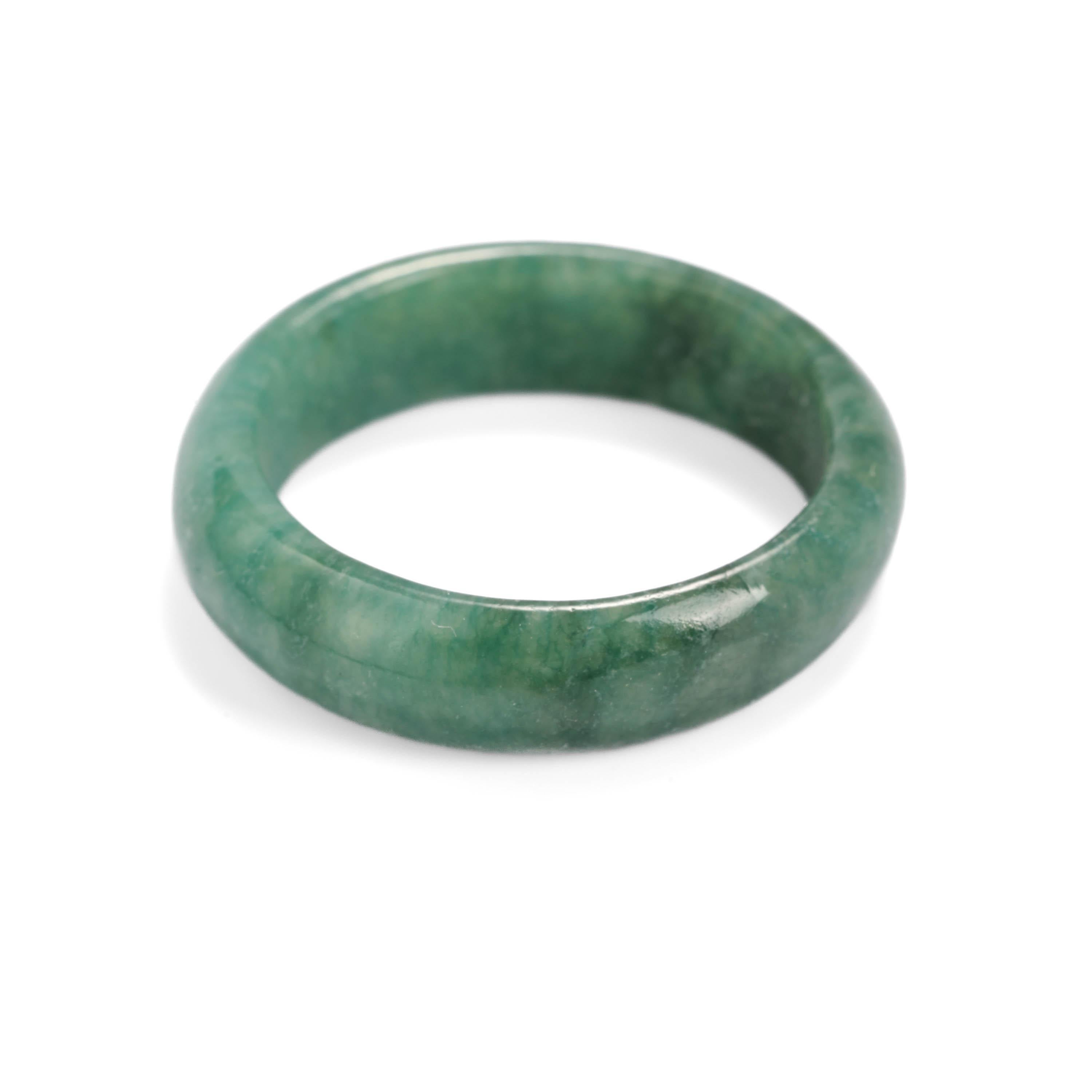 Rich green with a hint of blue -just like the finest emeralds from the legendary mines of Colombia, this is a rare find, indeed. A hand-carved band of pure, natural and untreated jadeite jade. Slightly mottled and highly translucent, the band is