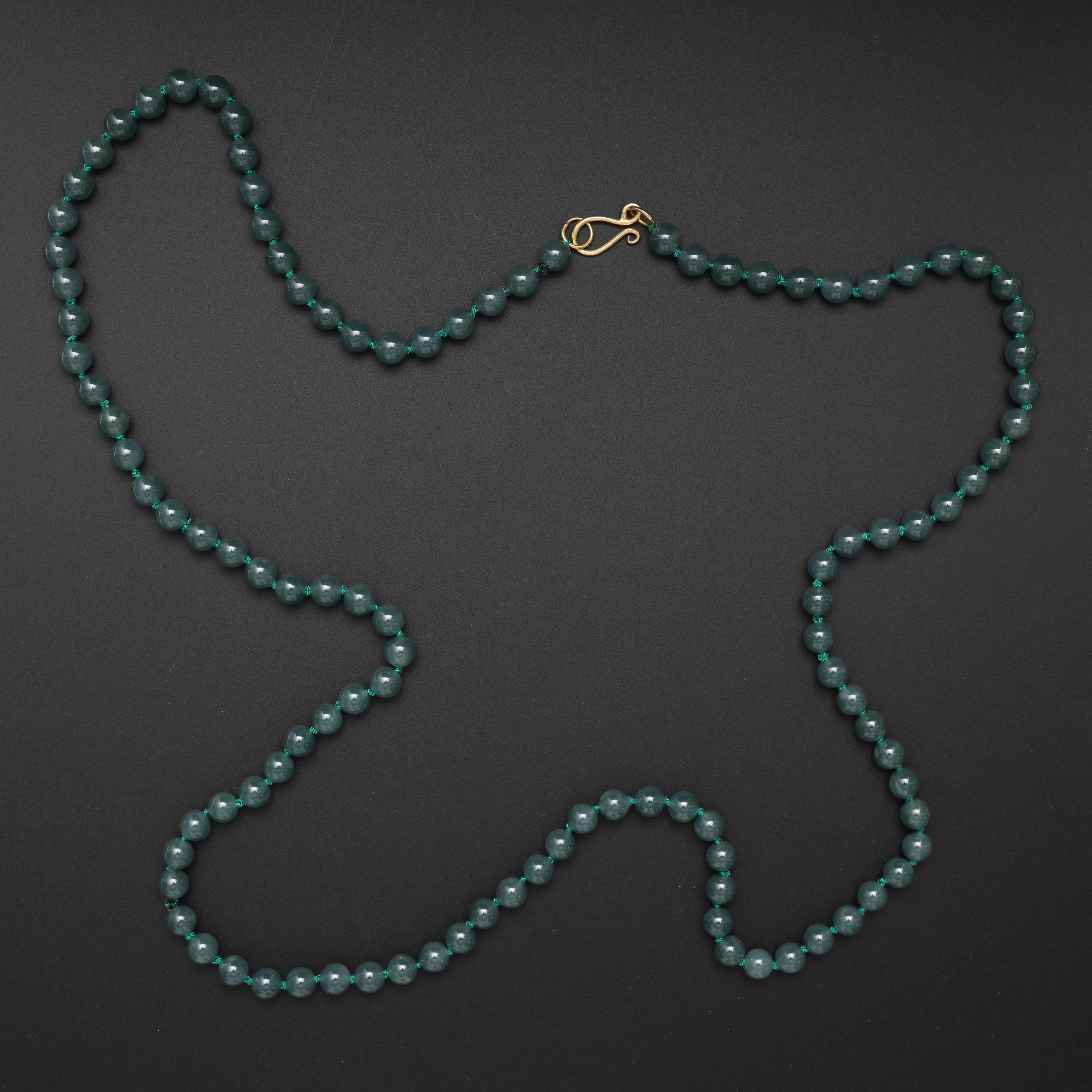 An absolutely stunning jade bead necklace of translucent bluish-green certified natural and untreated jadeite jade beads. These extraordinarily translucent beads are a most uncommon shade of bluish-green. They are so exceptionally translucent they