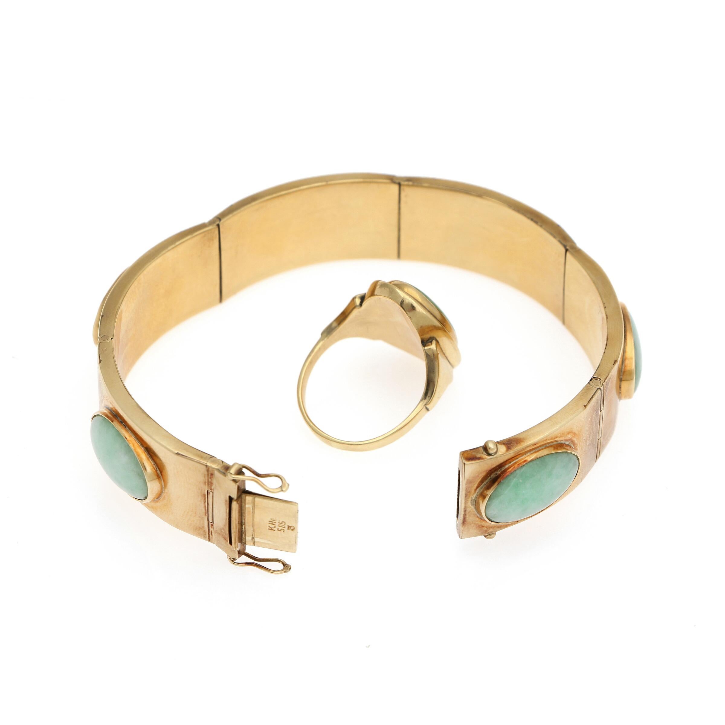 A jade jewellery set by Danish designer Knud Hejl, comprising a bangle and a ring each set with jade, both mounted in 14-karat gold.