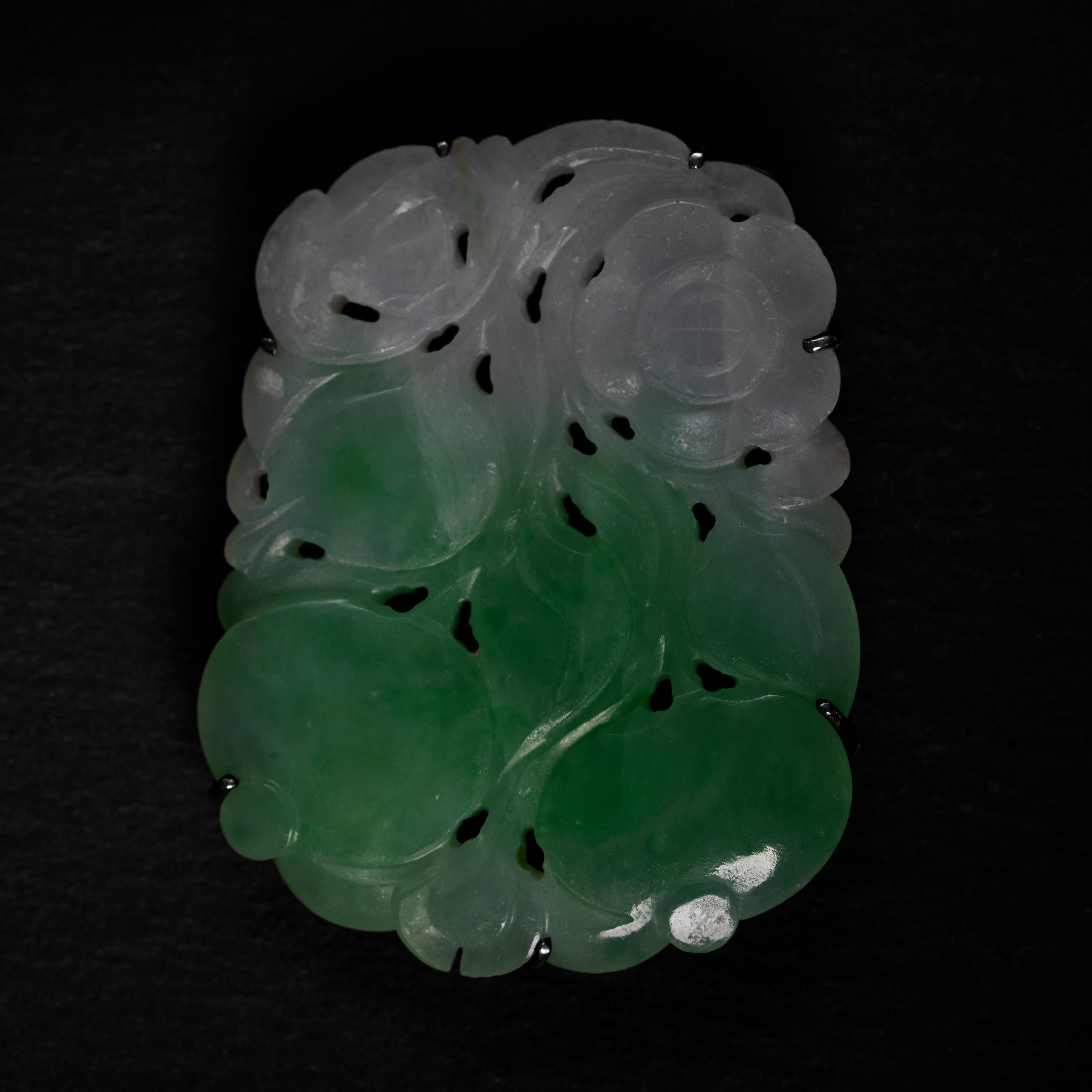 It's a carving of peaches; symbolic of longevity. But look at those carved lines on the upper-left quadrant. Ever see a peach with lines like that? What makes this carved jadeite jade brooch so magnificent is the artistic license on full display.