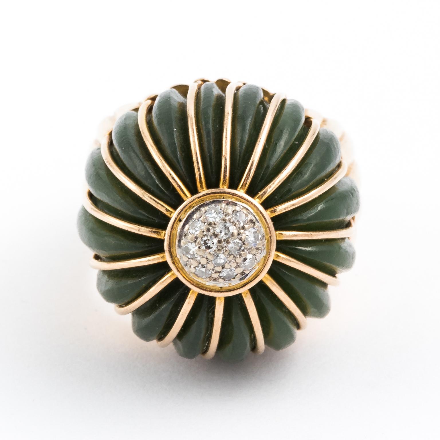 Circa 1960s Jade cocktail ring set in 14 karat gold with visually designed lineal strips of gold going down the large 0.50 centimeter jade dome.
