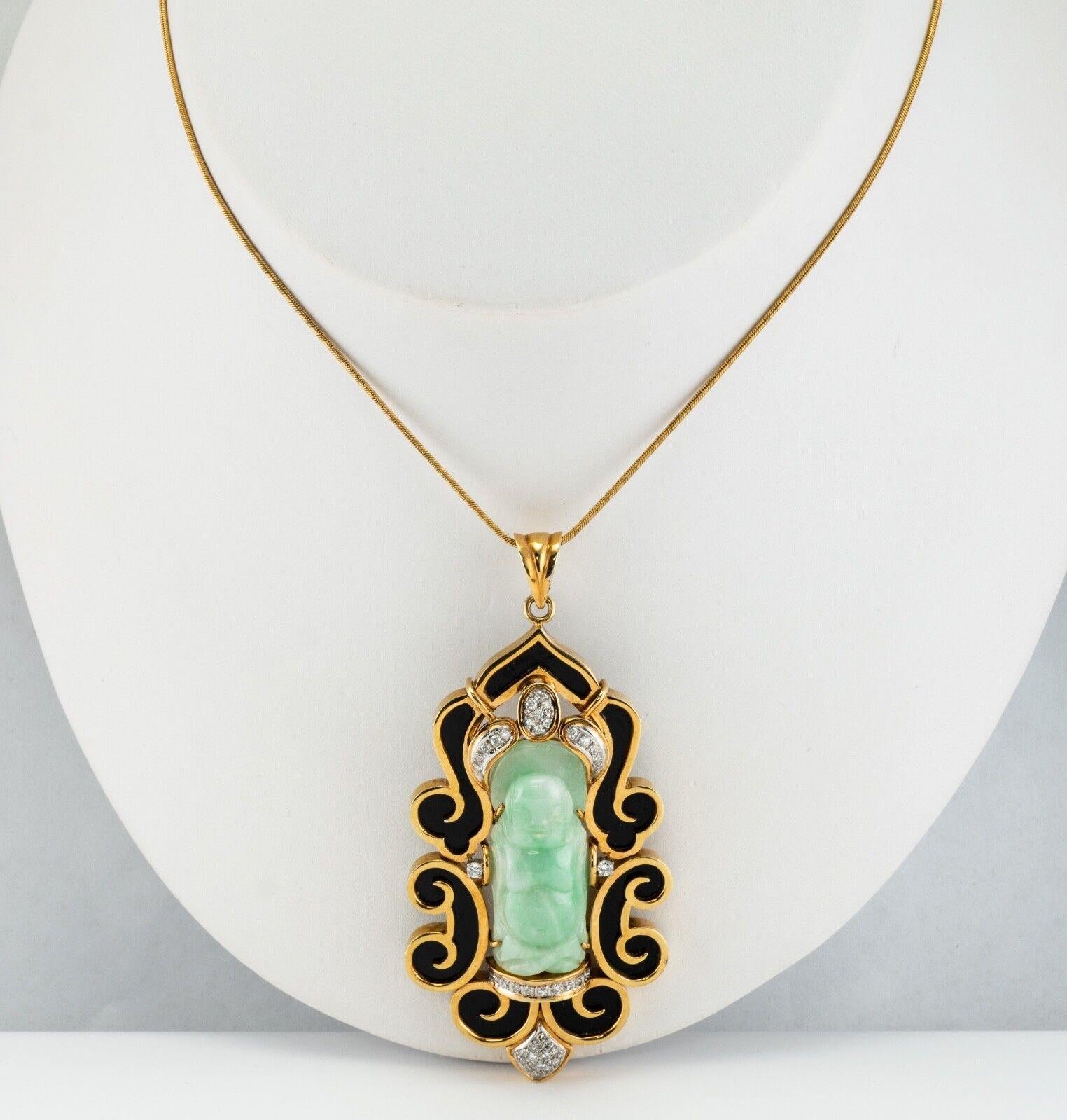 This one of a kind estate pendant is finely crafted in solid 14K Gold and set with a genuine carved Jade, diamonds, and black onyx. The carved Buddha measures 1-5/16