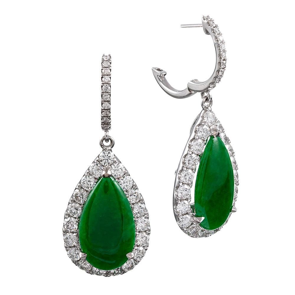 These pear cabochons of dark apple green jade offer an intense hue to compliment any palette. Framed by brilliant white diamonds and suspended from modest hoops to hug the ear lobe, the earrings measure 1.25 inches long and are ideal for both casual