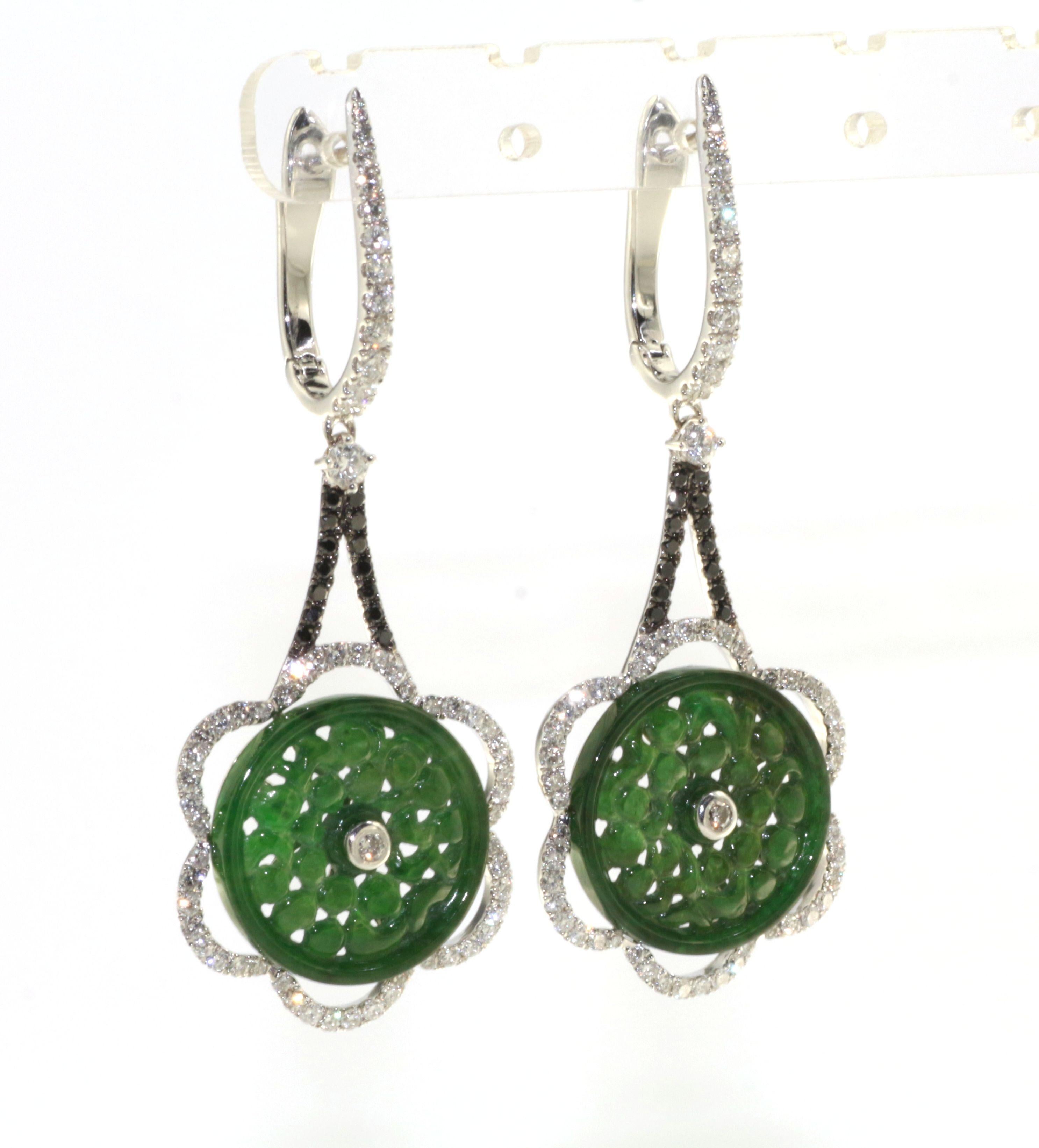 Introducing our exquisite vintage jadeite and diamond dangle earrings, a stunning pair that effortlessly captures the essence of timeless beauty. Crafted in 18 karat rhodium black gold, these earrings exude a sense of sophistication and allure.

The
