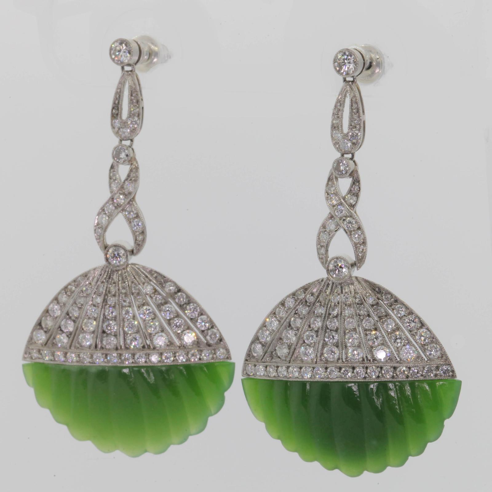 Beautifully hand crafted, articulated platinum earrings featuring stylized fluted shells of green Nephrite Jade.  The Jade plaques are suspended from platinum diamond caps and a swirl style bars.  The total diamond weight is 2.70 carats of Round