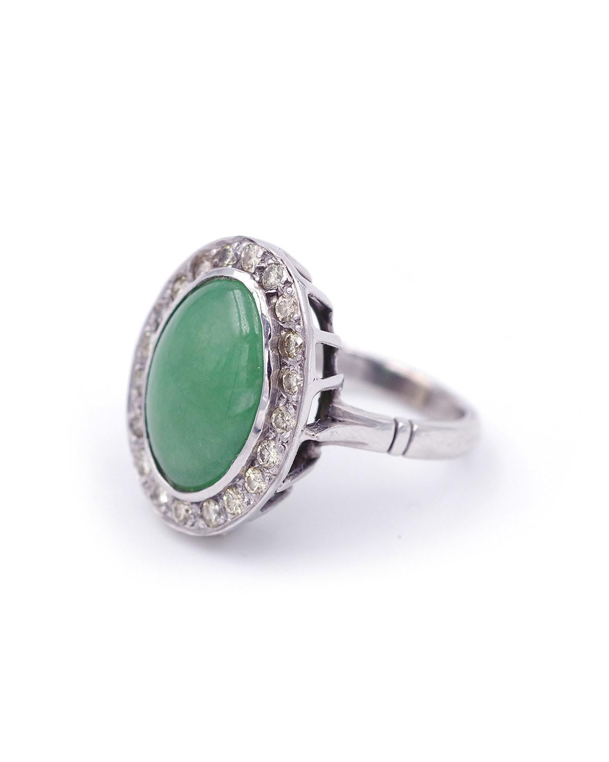 Diamond jade ring in 18 karat white gold. Ring centered on a 4-carat jade jadeite cabochon, surrounded by 20 brilliant-cut diamonds. Vintage ring, circa 1970, France. 

Eagle head hallmark and French goldsmith's hallmark

Finger size: 49 UE or 5 US