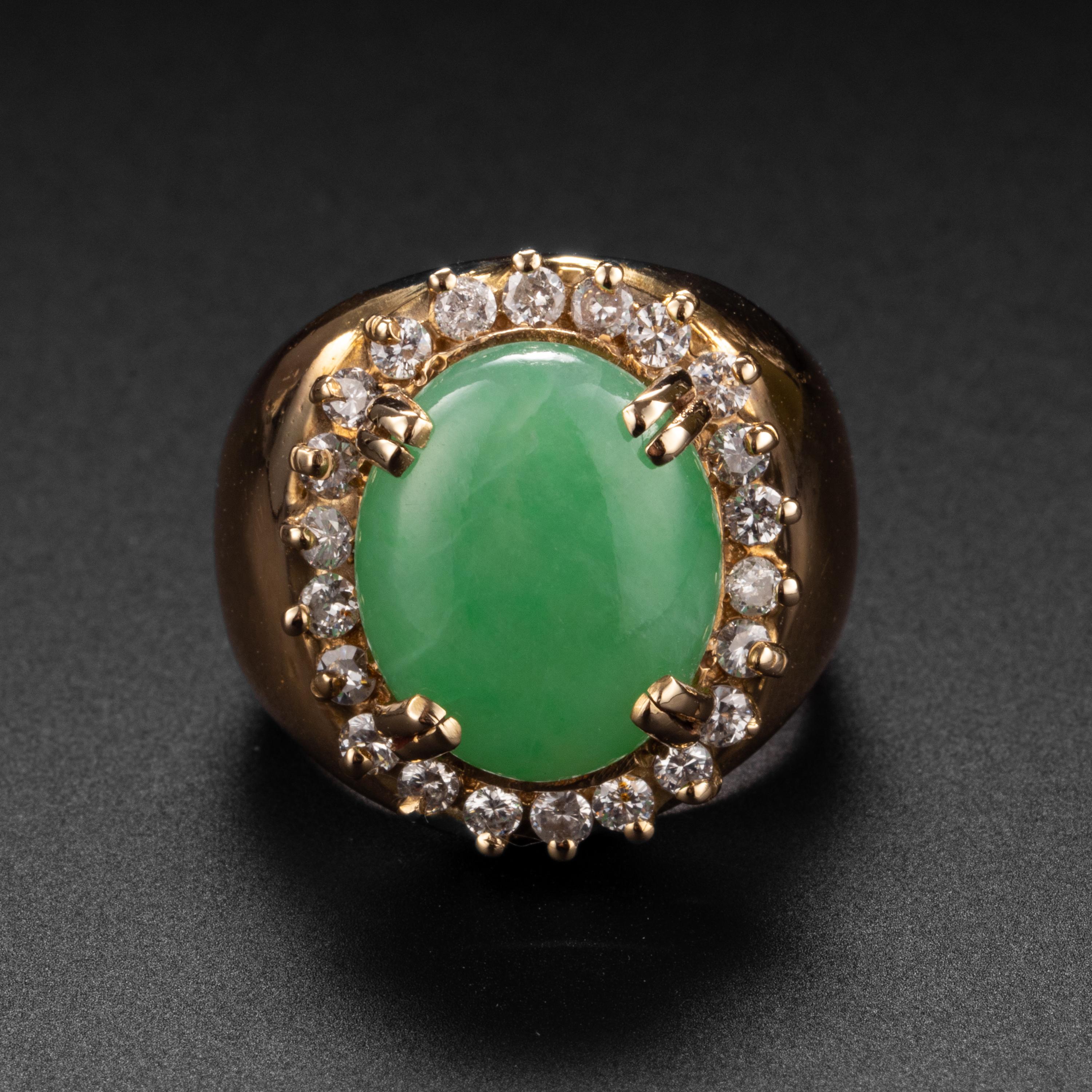 This lovely ring from the 1960s (or thereabouts) features a bright apple green cabochon of natural, untreated jadeite that is prong-set and surrounded by a halo of diamonds. The jade stone is highly translucent and measures 13.16 x 10.92 x 4.44mm.