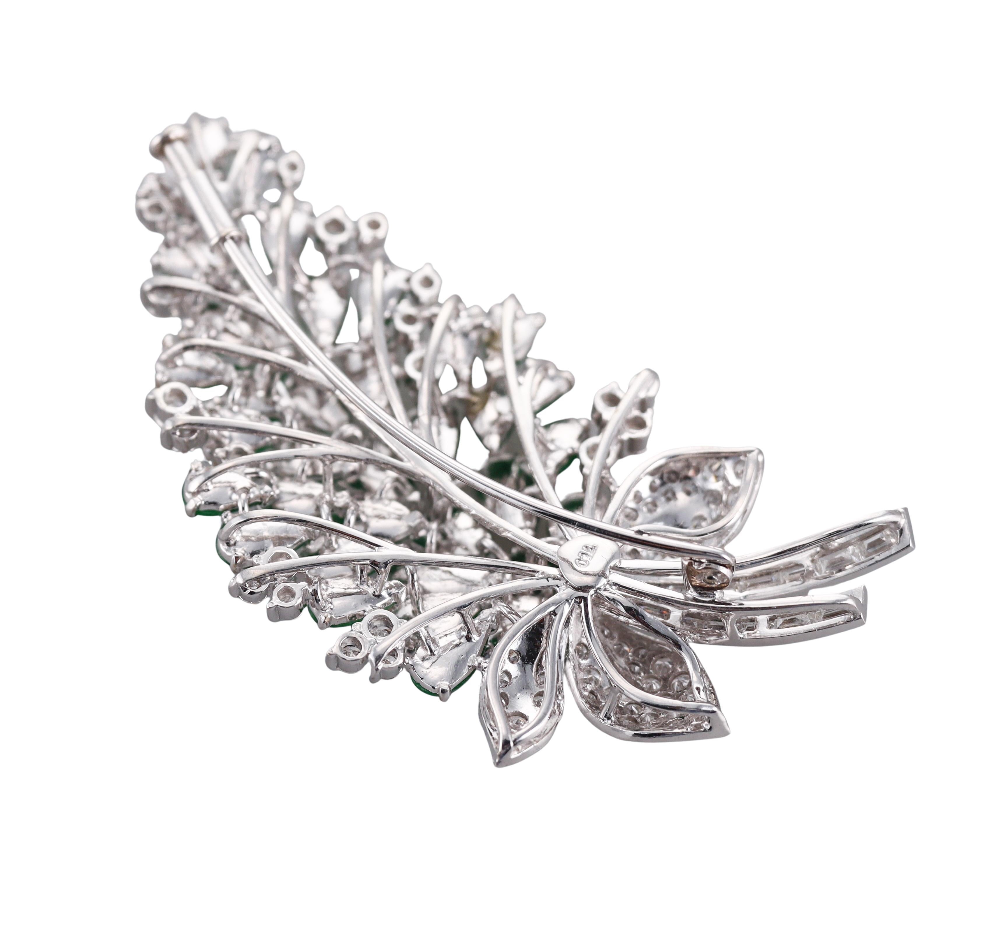 An 18k white gold brooch, featuring pear shaped green jade stones, surrounded with approx. 0.90ctw H/VS-Si diamonds. 
Brooch is 2 3/8