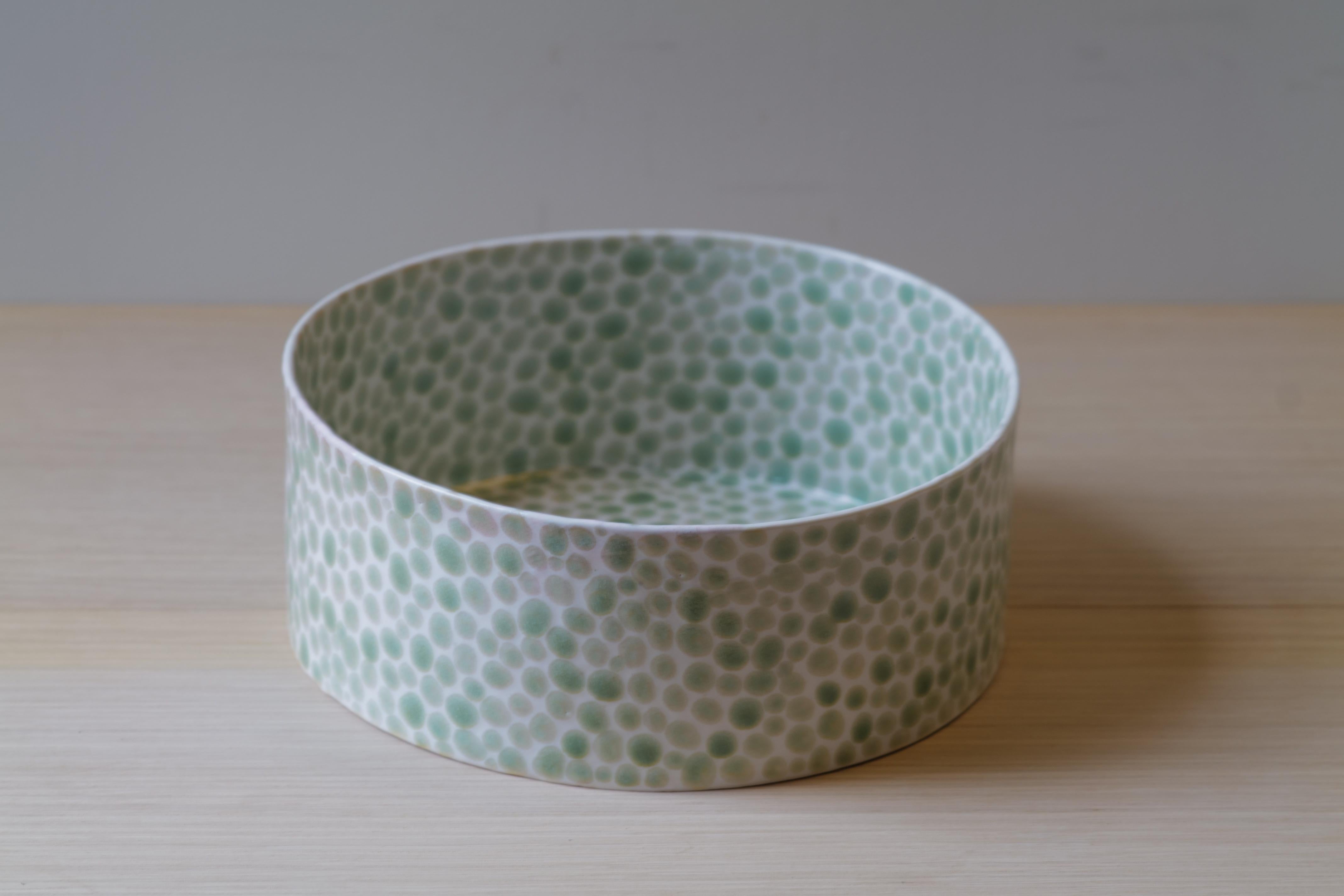 This porcelain large bowl was made in NYC by artist Lana Kova. It is slip casted in mold and then fired , hand painted and fired again. It is very precise in its painting of dot pattern and thin for its size. This piece makes a beautiful addition to
