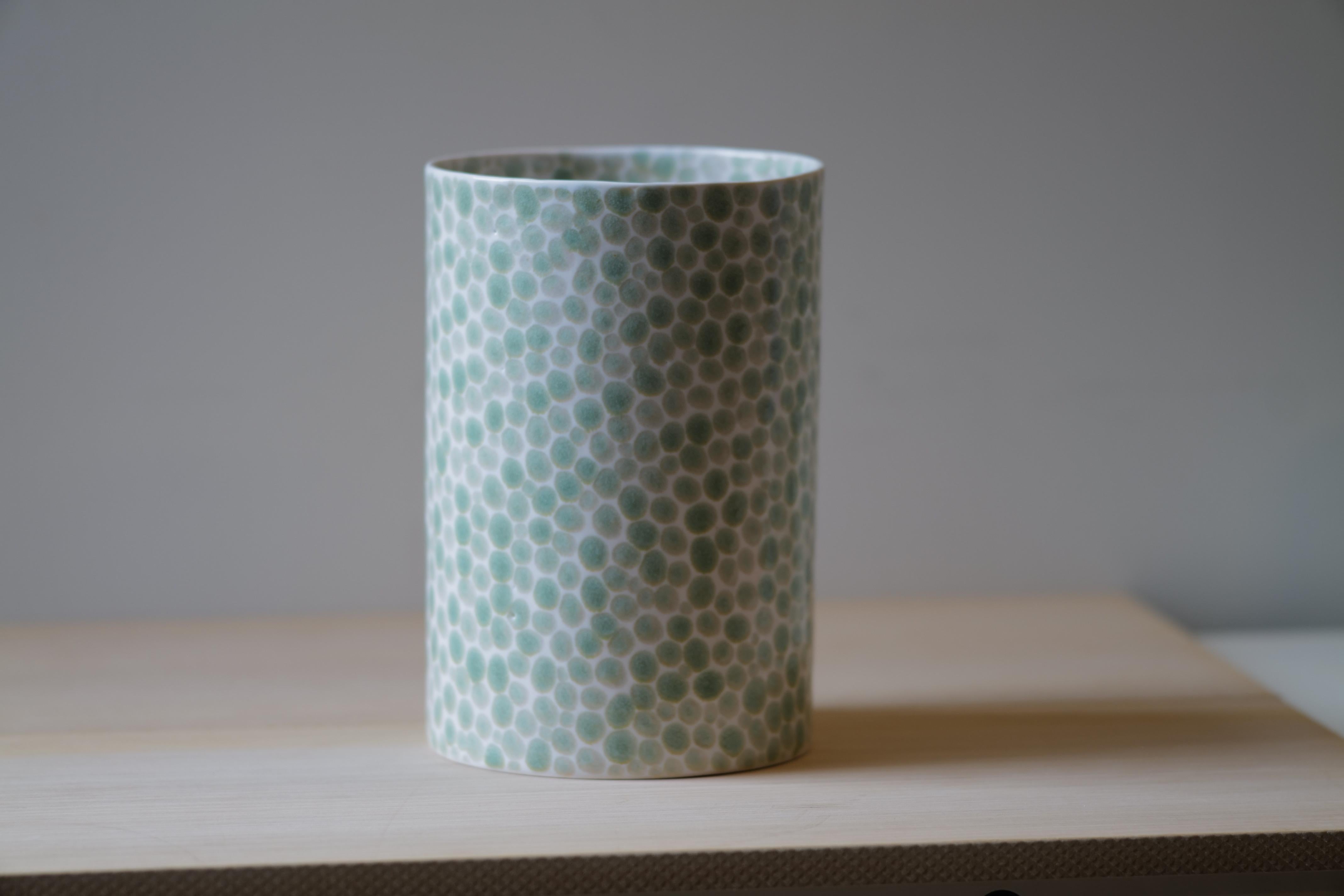 This porcelain large vase was made in NYC by artist Lana Kova. It is slip casted in mold and then fired hand painted and fired again. It is very precise in its painting of dot pattern and thin for its size. This piece makes a beautiful addition to