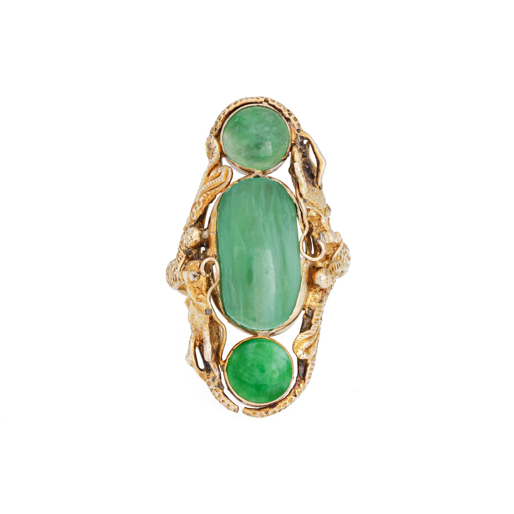Unique & sylish vintage dragon ring (circa 1970s) crafted in 14 karat yellow gold. 

Jade measures 15mm x 8mm (center) and 6.5mm. The jade is in very good condition and free of cracks or chips. 

The elaborate ring highlights two dragons, coiled