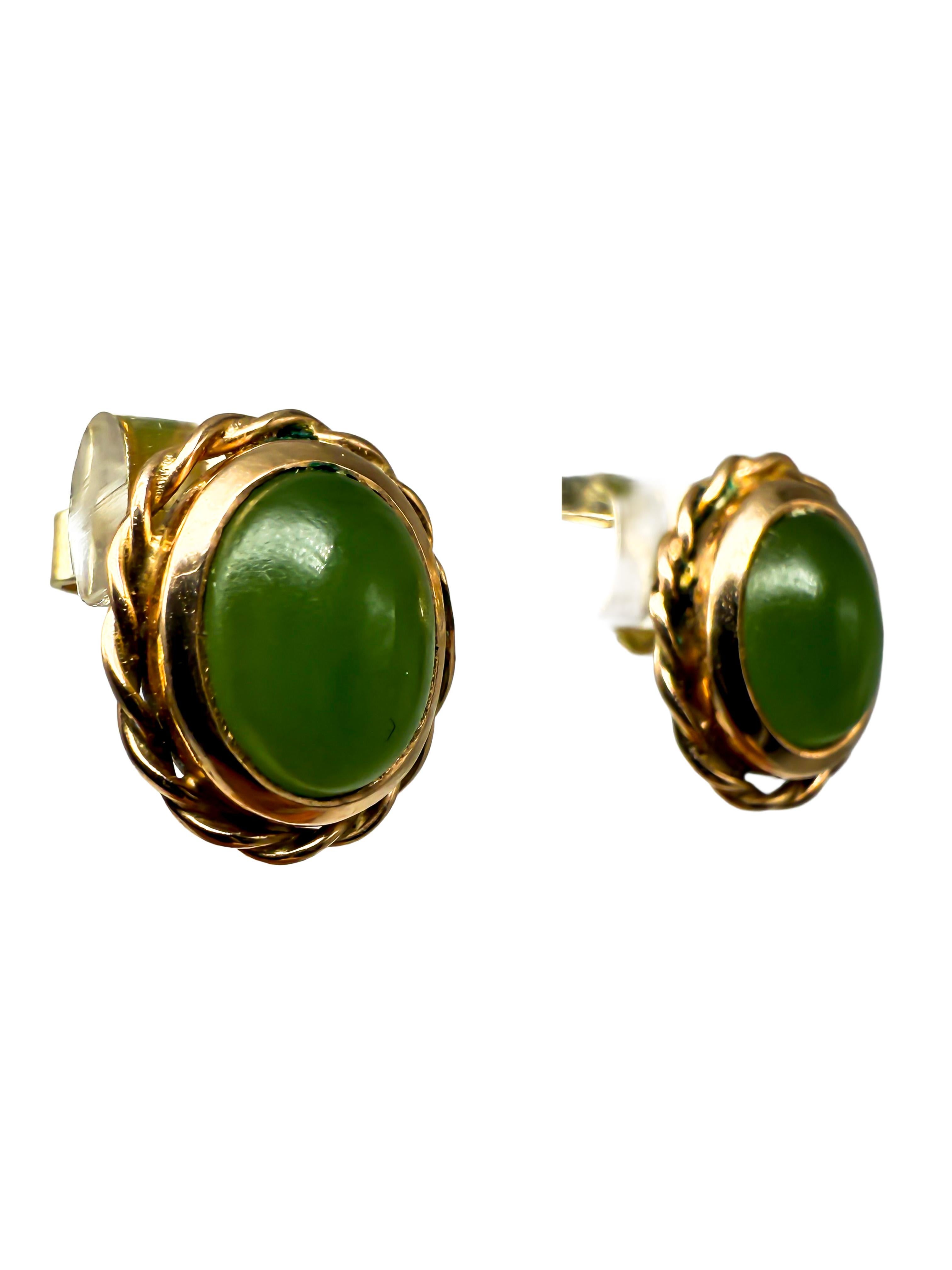 Ces élégantes boucles d'oreilles en or jaune 14 carats séduisent par leur simplicité classique et l'éclat naturel des cabochons de jade.

Les pierres de jade vert de taille ovale sont solidement serties dans des chatons, mettant harmonieusement en