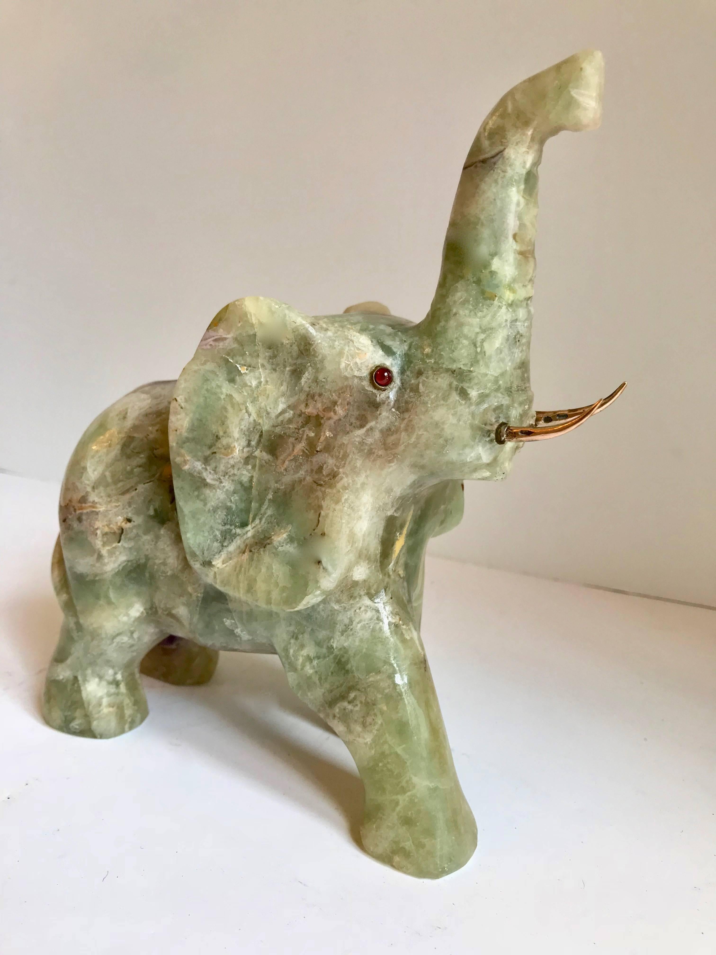 Jade elephant with 14-karat gold tusks, a unique jade piece with amber eyes inlaid in sterling. Bring good luck to any shelf or desk in your space, the trunk is up and ready to make all your wishes come true!

Would make a handsome bookend or