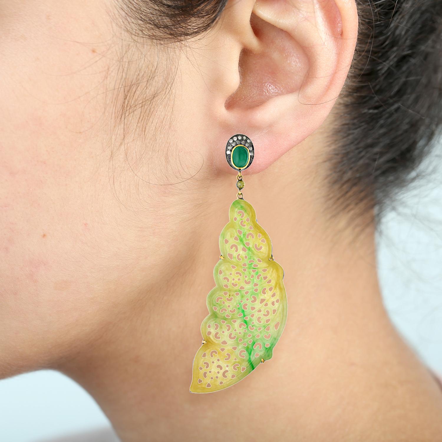 Exquisite feather shape jade earring with diamonds and emerald on top. 
Closure: Push post 

18Kt:2.92g
D:0.6ct
Emerald-2.60cts
Jade-65.60cts

