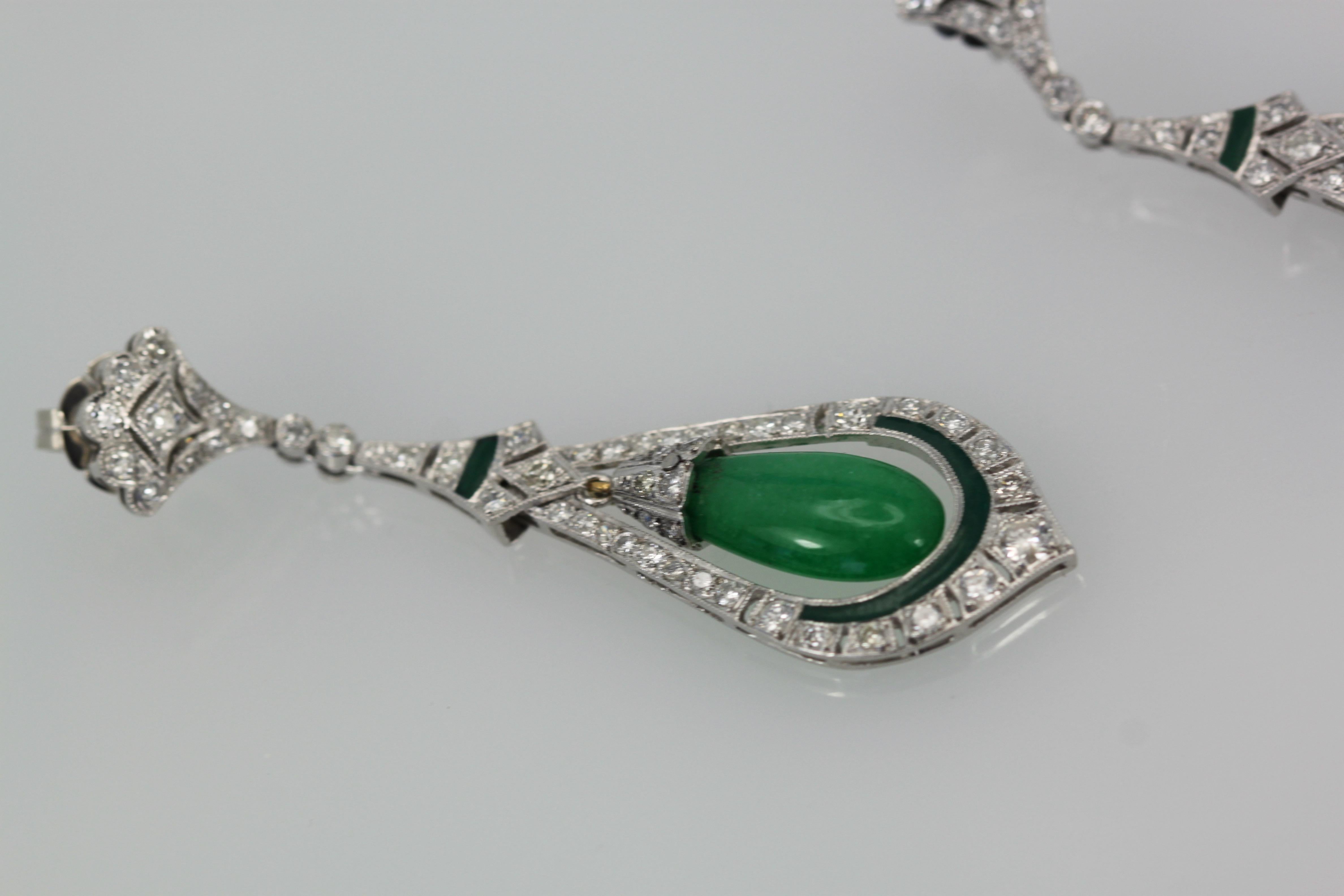 These beautiful Jade Enamel Diamond long drop earrings consist of a teardrop Jade surrounded by Diamonds and green (same color as the Jade) Enamel.  These earrings come from Spain and weight 16.2 grams.  They are 5.3mm wide and 2 1/2