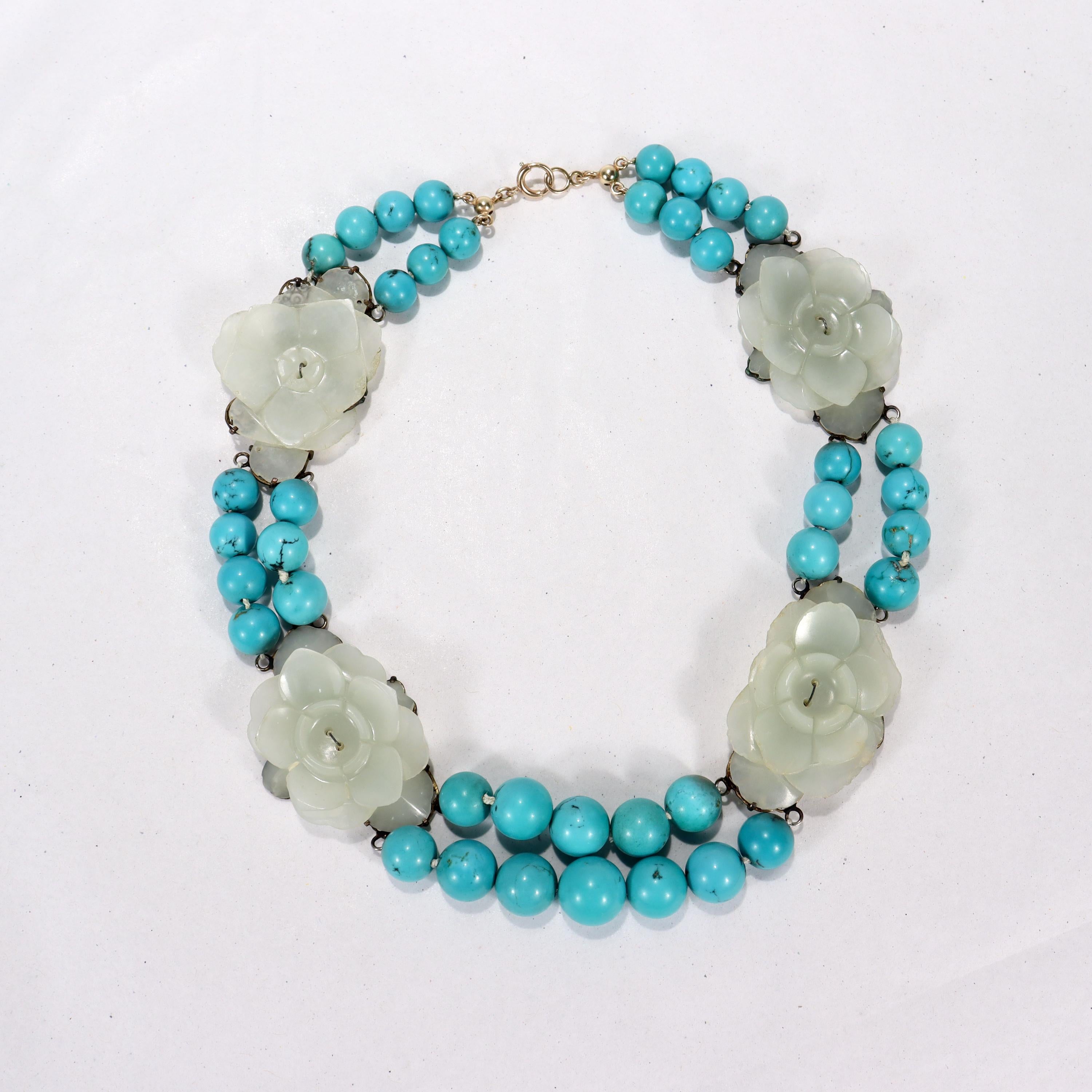 A very fine Jade and turquoise necklace.

Comprised of large, older (or possibly antique and very likely Chinese) carved jade flowers prong set on silver filigree backs strung between double strand segments of turquoise beads. We think this is a