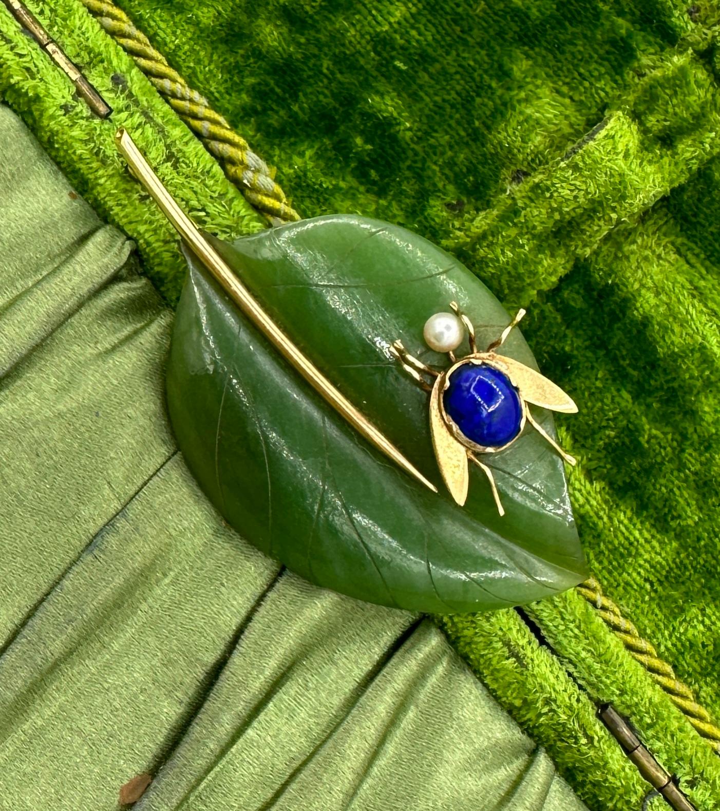 This is an absolutely stunning Jade, Lapis Lazuli and Pearl Fly Bug Insect on a Leaf Brooch Pin in 14 Karat Yellow Gold.  The fabulous fly or insect has a lapis lazuli cabochon body and a pearl head.  Its wings and legs are gold.   The bug rests on