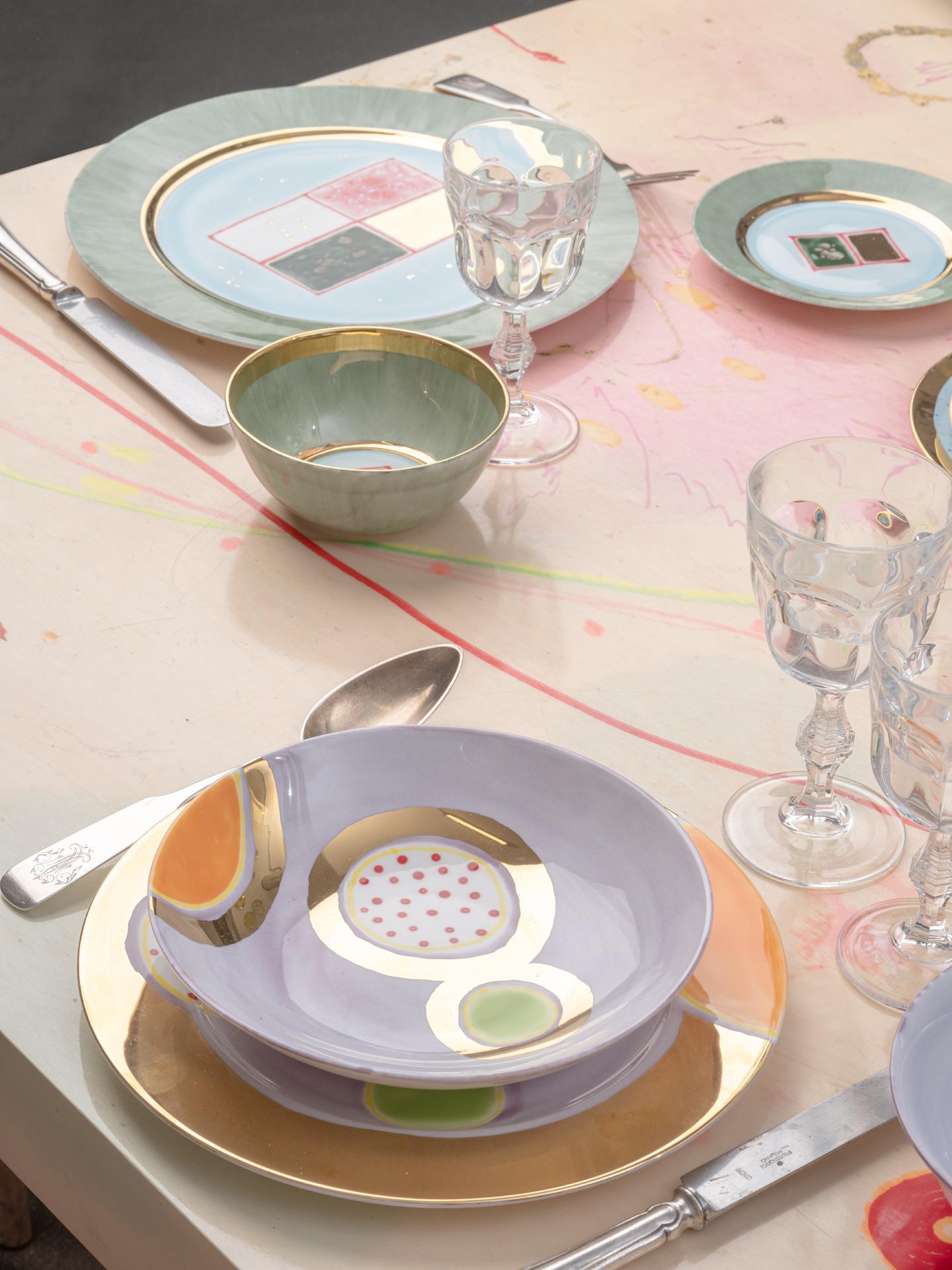 The Gold Impressions collection takes Coralla's exploration of geometry and minimalism to a new dimension, infusing her iconic designs with radiant gold accents. These golden elements transform familiar symbols, like the Mountain, into luminous