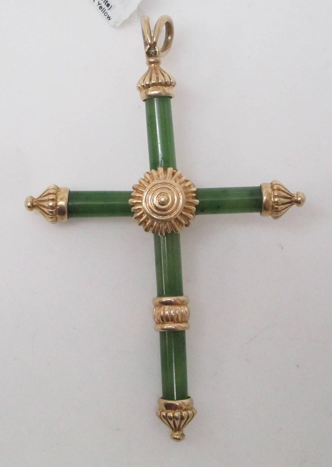 This is an exquisite Jade (Nephrite) cross, set in 14K yellow gold. It carries the sun at it's heart and will brighten the day of the wearer. This is not a cross you will see everywhere. 

St. John and Myers Jewelry is the only jeweler in Central