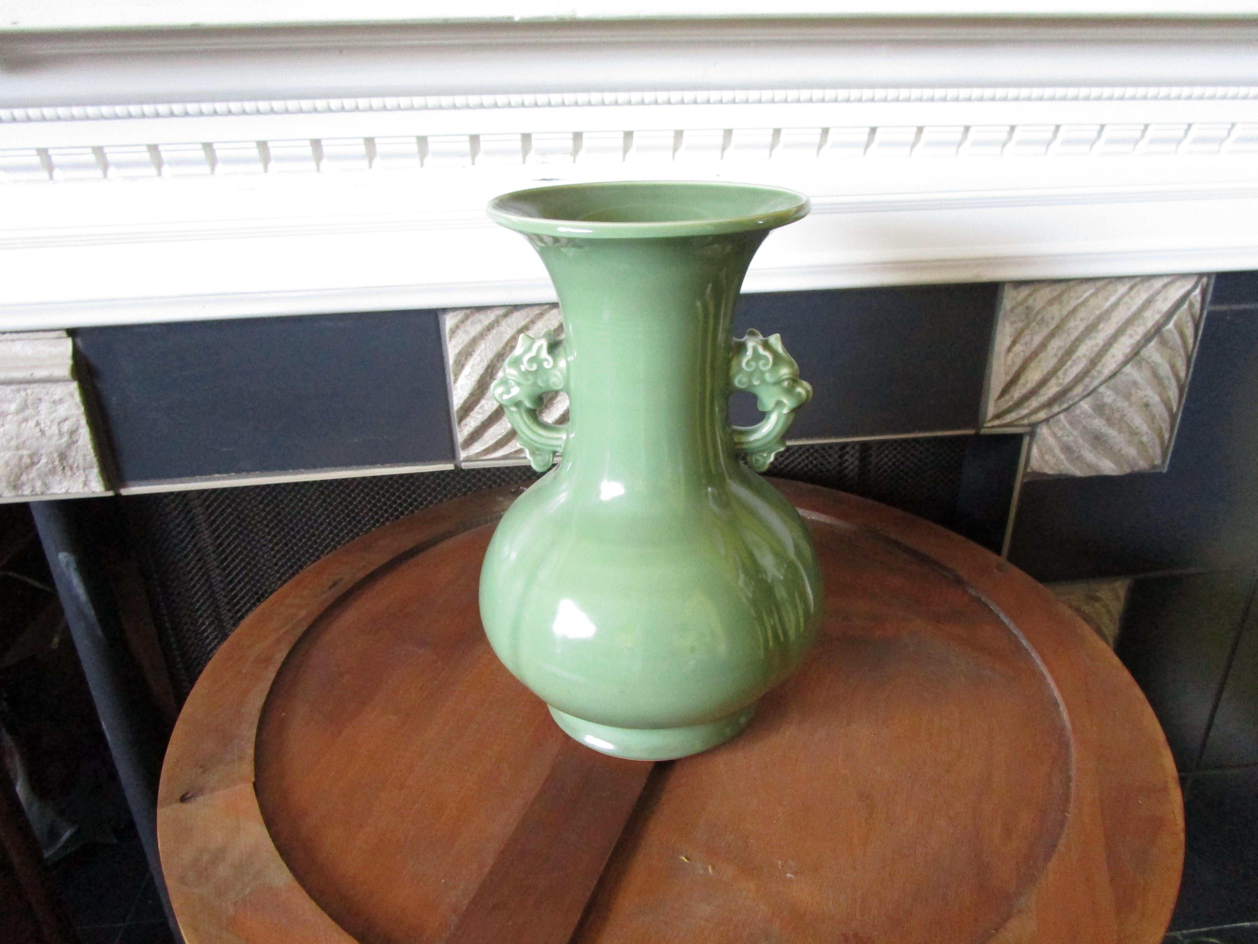 This is an extraordinary jade green celadon Korean vase from the mid 20th century. The vase is baluster shape with an elongated, elegant neck.  It is in excellent condition without chips or cracks. There is a deep fluting on the body of the vase