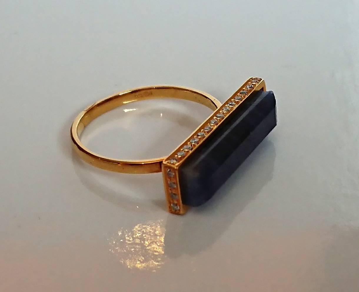 An amazing Sapphire & Diamond Ring from jewellery designer Jade Jagger. Featuring a rectangular Sapphire set into 14ct gold with inlay diamond border. The hand carved sapphire sits raised 6mm above the finger fully hallmarked with makers mark and