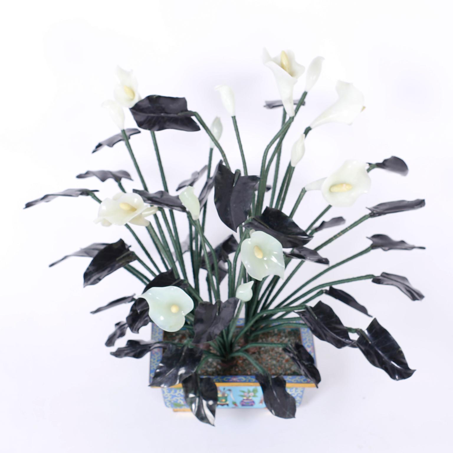 Chinese lily plants with white jade flowers, spinach jade leaves, silk wrapped metal stems and arranged in a cloisonné planter.