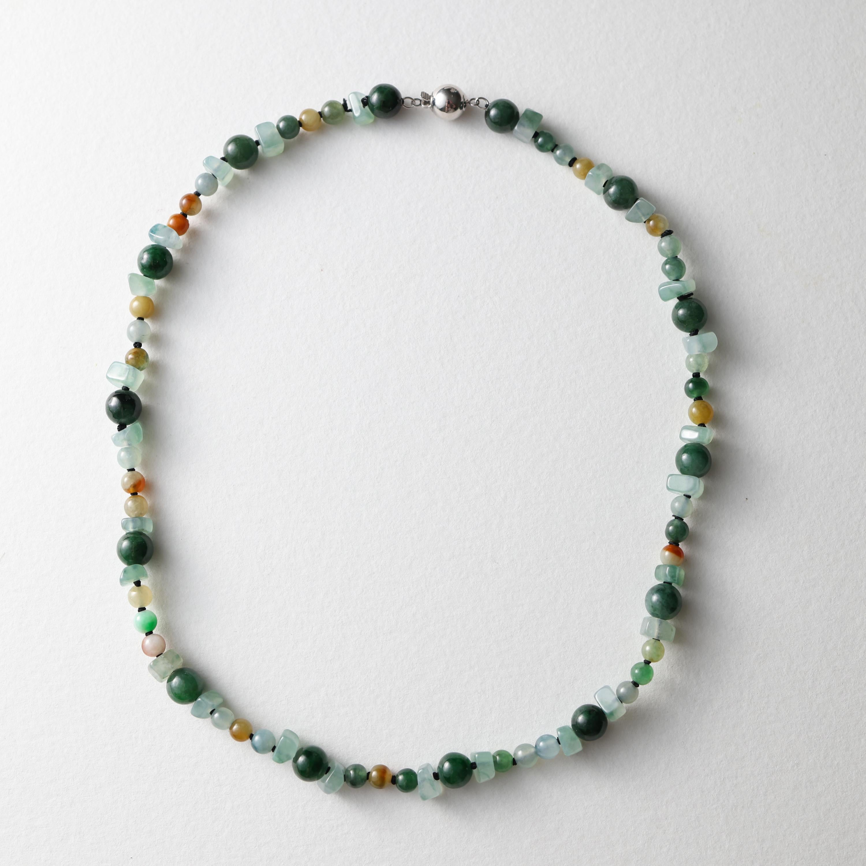 This brand-new beaded jade necklace features both jadeite jade and omphacite jade beads. The beads represent a spectrum of gorgeous, vivid colors -from warm reds and oranges to cool blues and greens, all in varying saturation levels. The highly