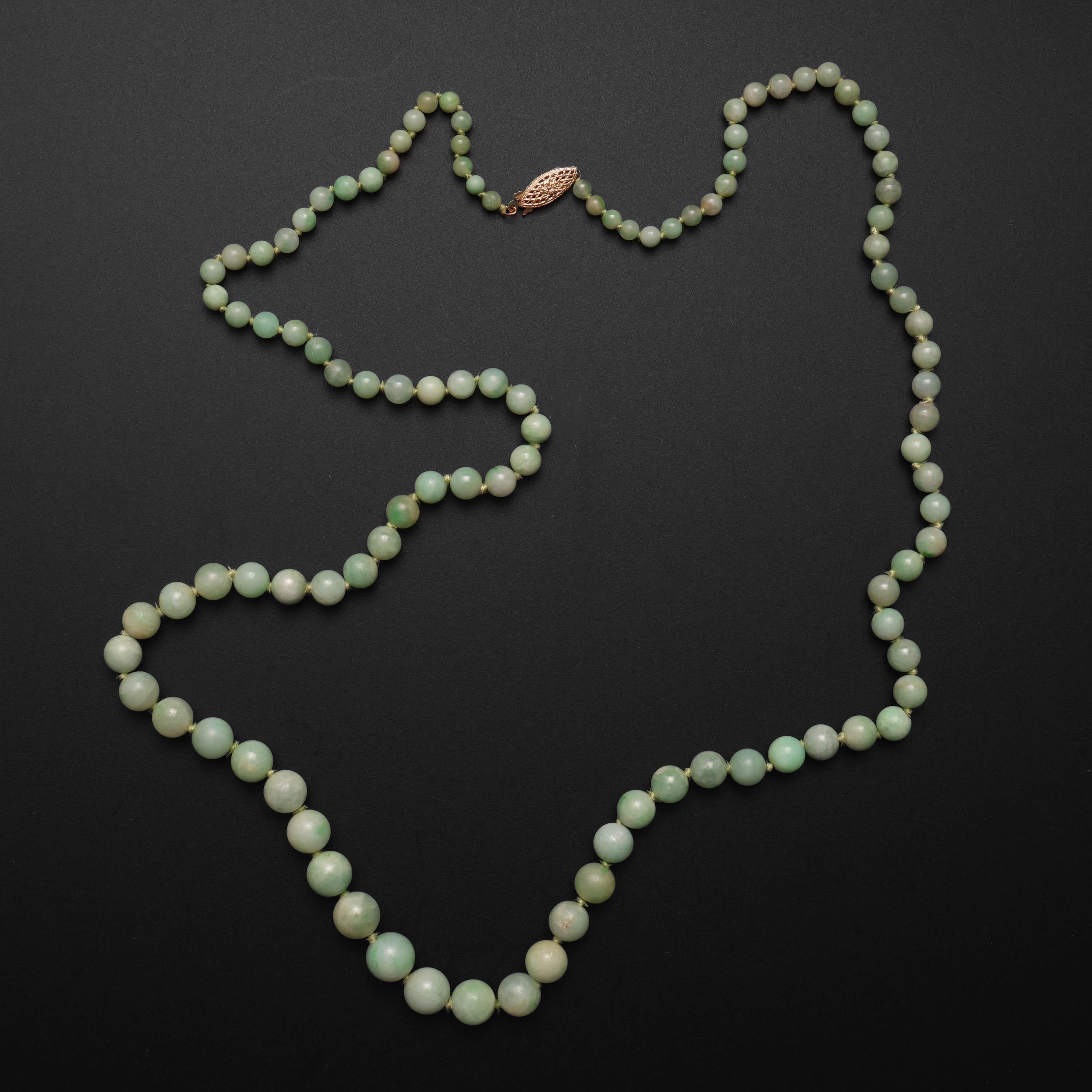 A spectacular certified natural and untreated jadeite jade necklace in variegated apple green. 

107 hand-carved and polished light apple green jade beads make for a 30
