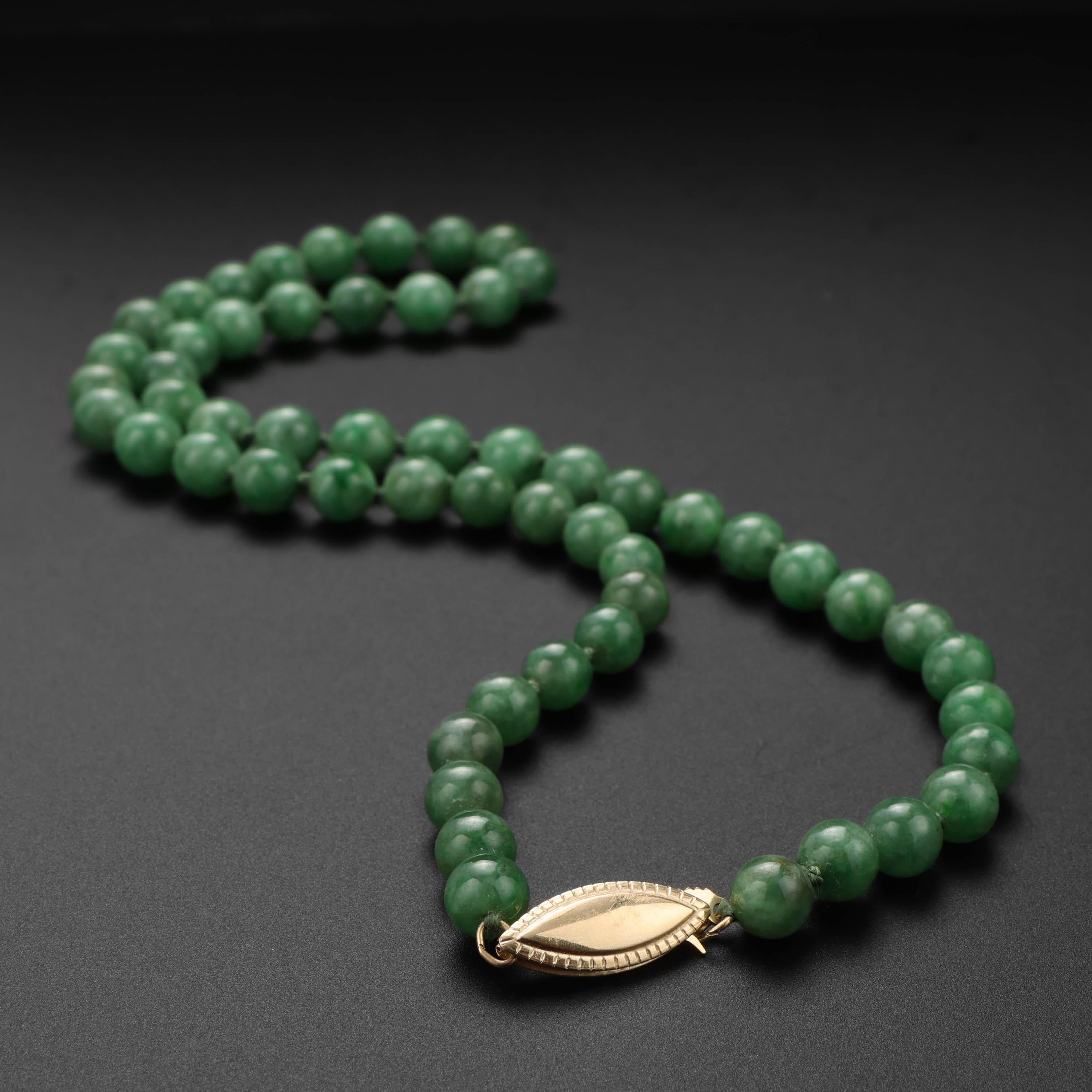 This gorgeous, emerald-green jadeite jade necklace features 56 natural and untreated jadeite jade beads that graduate in size from 6mm to 7.4mm. A 14k yellow gold marquise clasp completes the 16