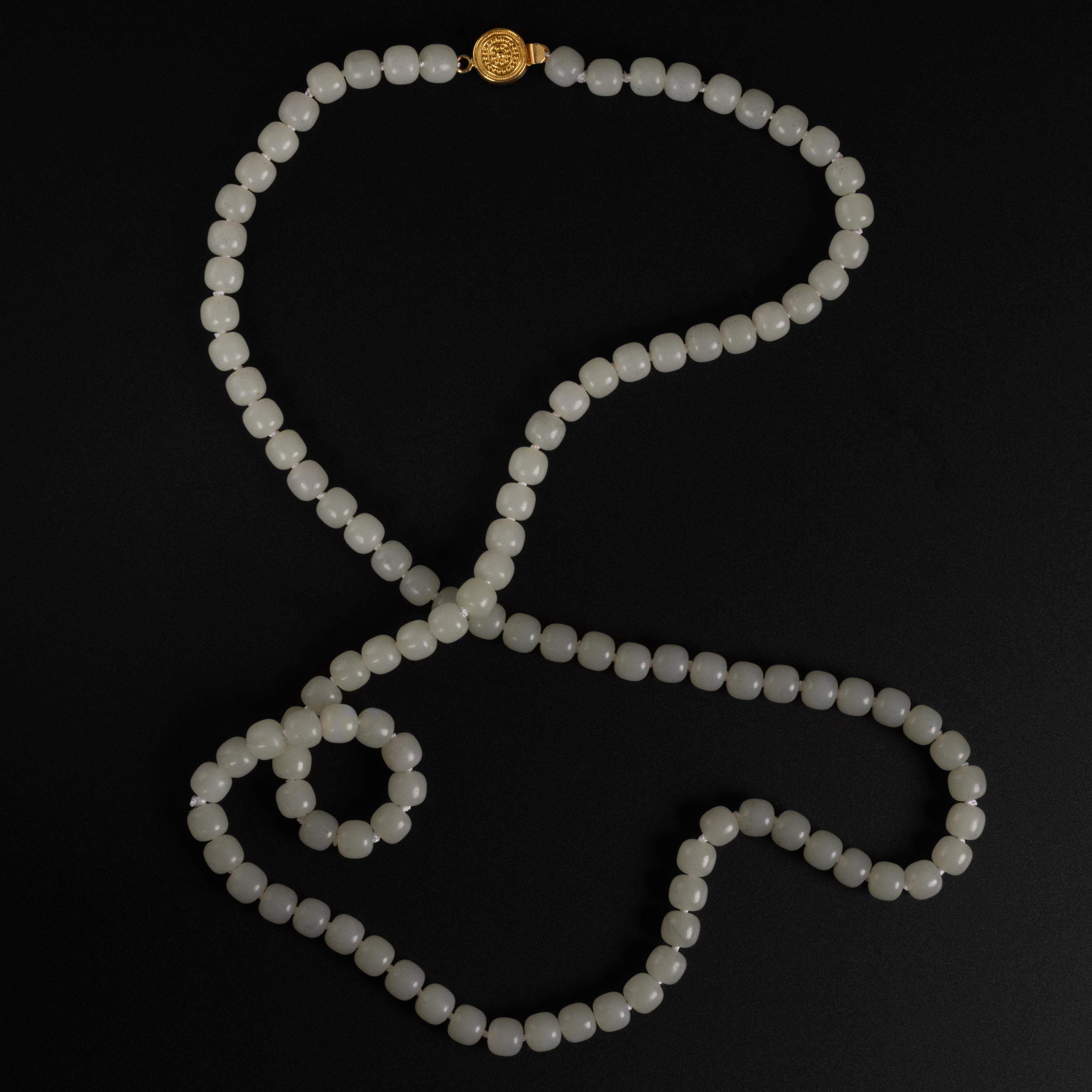 This gorgeous and unique necklace is composed of 109 8mm hand-cut and polished barrel-shaped white nephrite jade beads. The beads have a delicate polish; not slick and high gloss but rather old-school: waxy, subtle. Exactly the kind of polish that