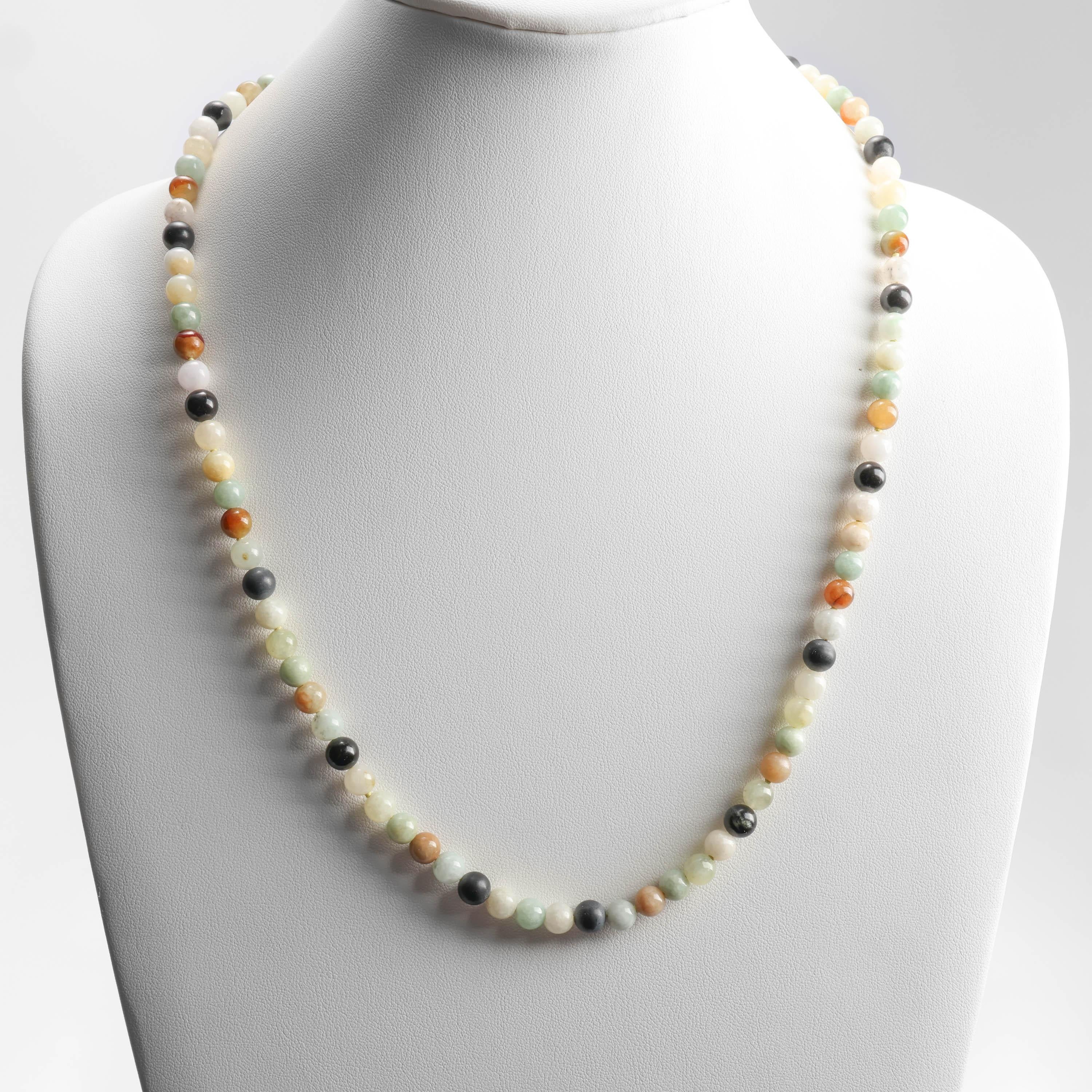 91 luminous, translucent multicolor jadeite jade beads create this stunning Midcentury necklace. The beads here are highly translucent and range in color from various shades of green, light yellow, honey, orange, black, and near colorless. Their